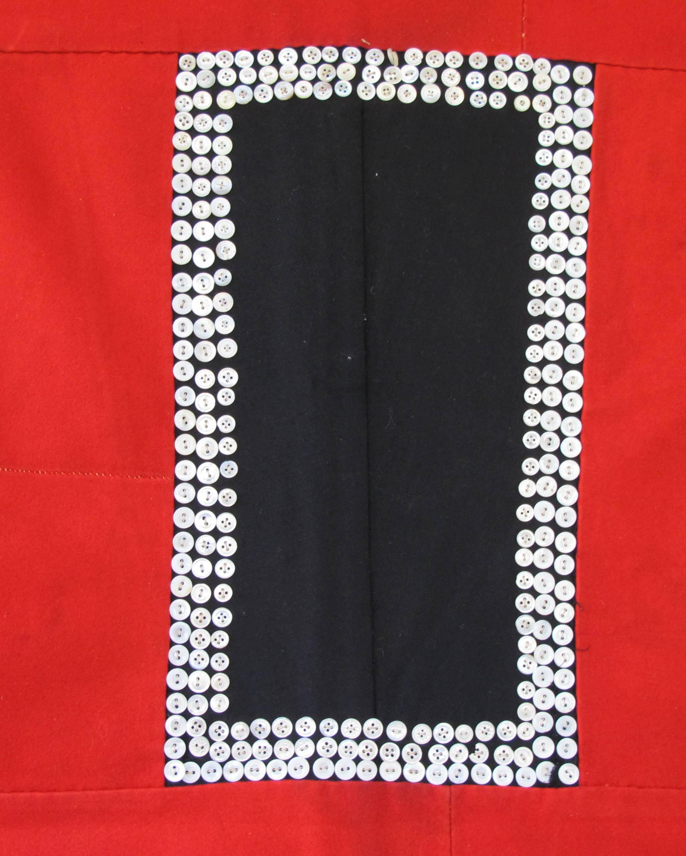 There was a tradition among the Tlingit people of the Northwest Coast for the women to make button blankets. Utilizing the wool blankets that they acquired through trade they made blankets with effigy clan images or as in this example bold geometric