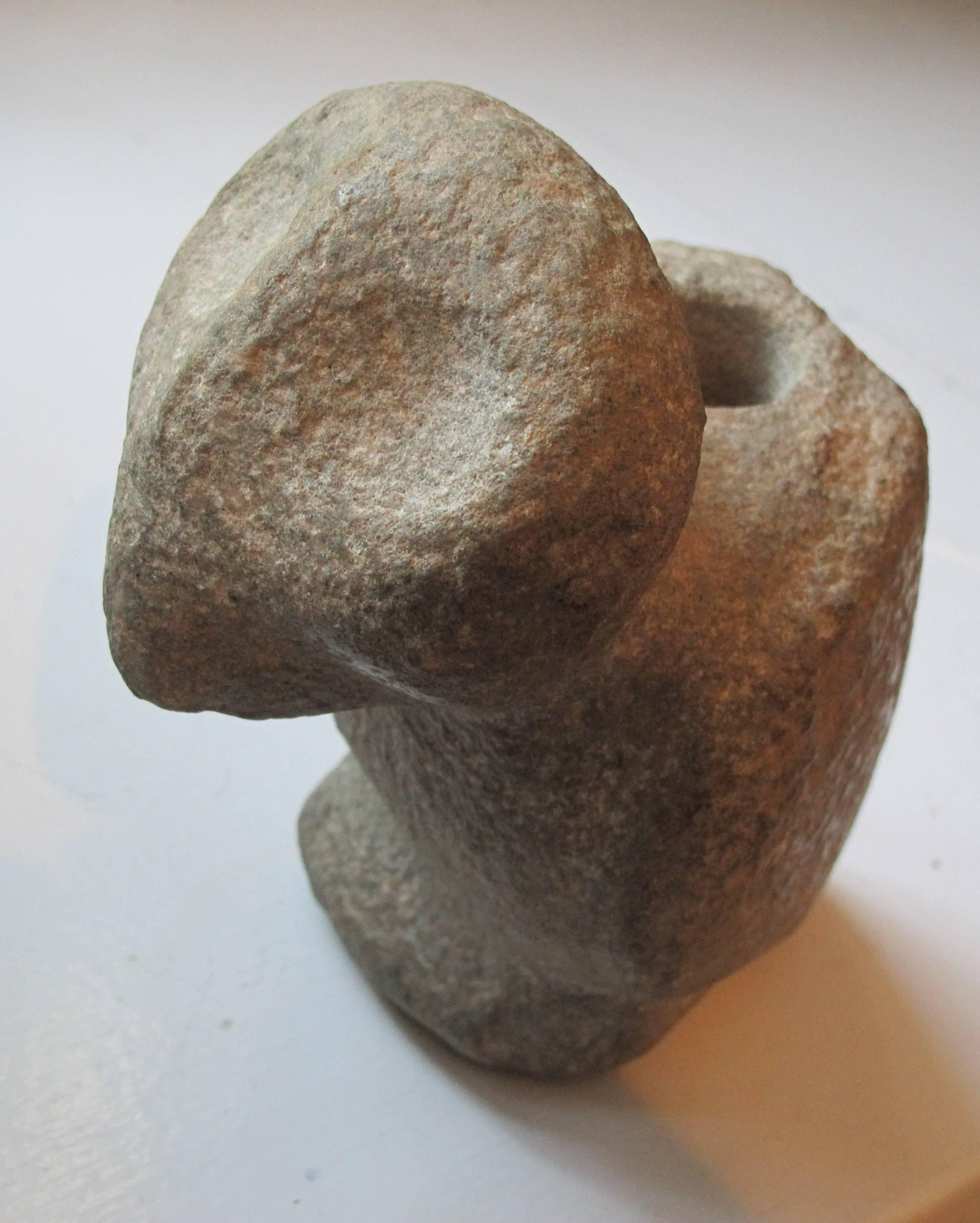 Chip carved sandstone bird effigy with forward thrust head with large socket eyes. There is a conical hole behind the head that connects to a second conical hole in the back between the wings. The prior owner had believed it to be a pipe as stone