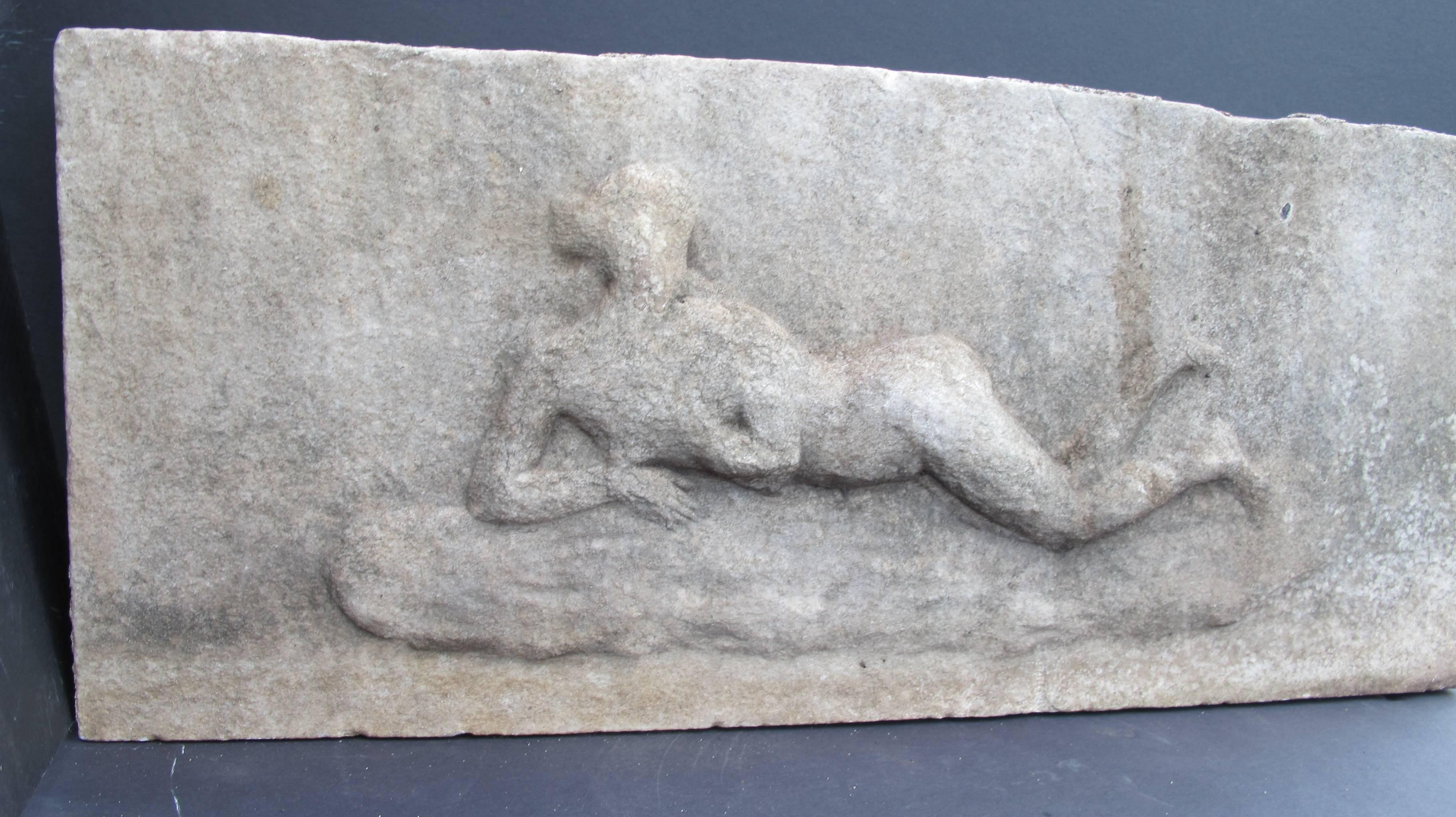 Carved marble building panel with reclining woman. The piece appears to have been installed outdoors, possibly in a garden as there is weathering and some oxidation. From a NY private collection and originally found in St Louis.