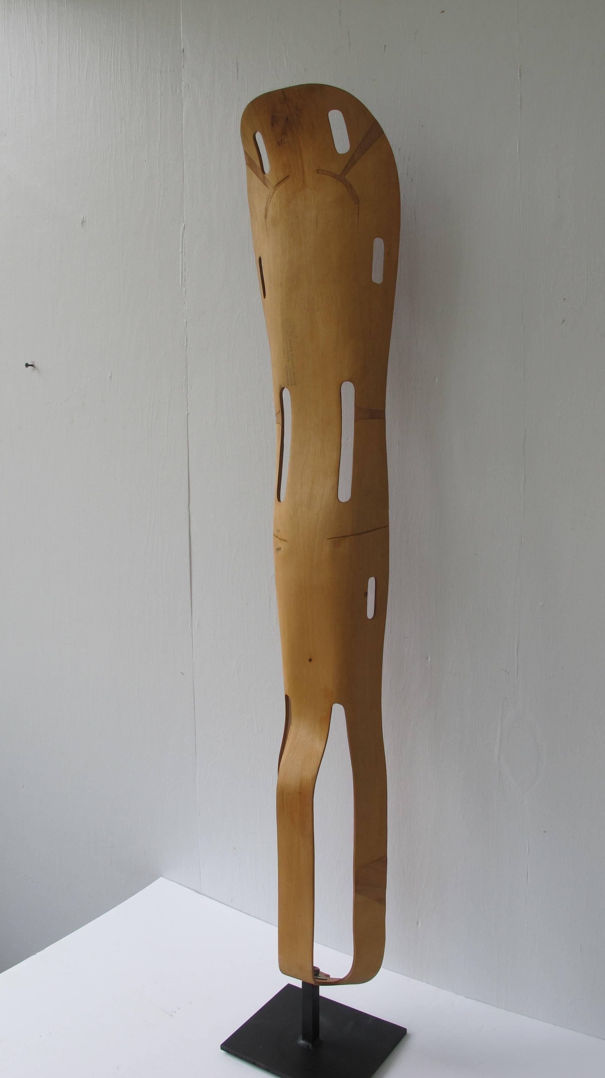 Charles and Ray Eames designed leg splint of sculptural and lightweight design. Made by Evans Products for the US military for use in WWII.
The plywood splint is mounted as a work of art on an American Primitive metal base for display. Paper label