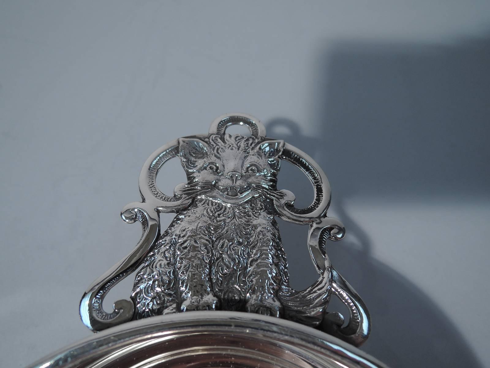 Sterling silver porringer. Made by Richard Dimes in South Boston. Upward tapering sides and flat rim. Open scroll handle inset with furry fluff ball. A great baby gift. Hallmark includes no. 137. Excellent condition.

Dimensions: H 1 3/4 x W 6 5/8
