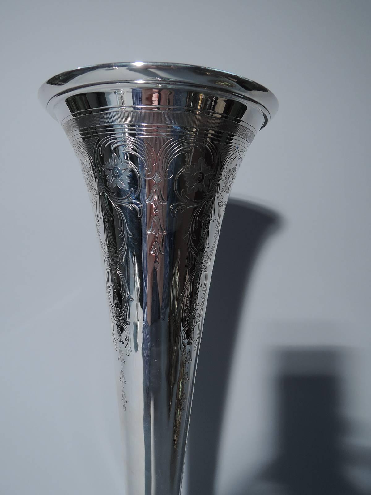 Art Nouveau sterling silver trumpet vase. Made by Tiffany & Co. in New York, circa 1915. Base knop, stepped foot, and molded rim. Engraved at top vertical ornament in form of stylized flowers and foliage as well as linear band and triangular frames.