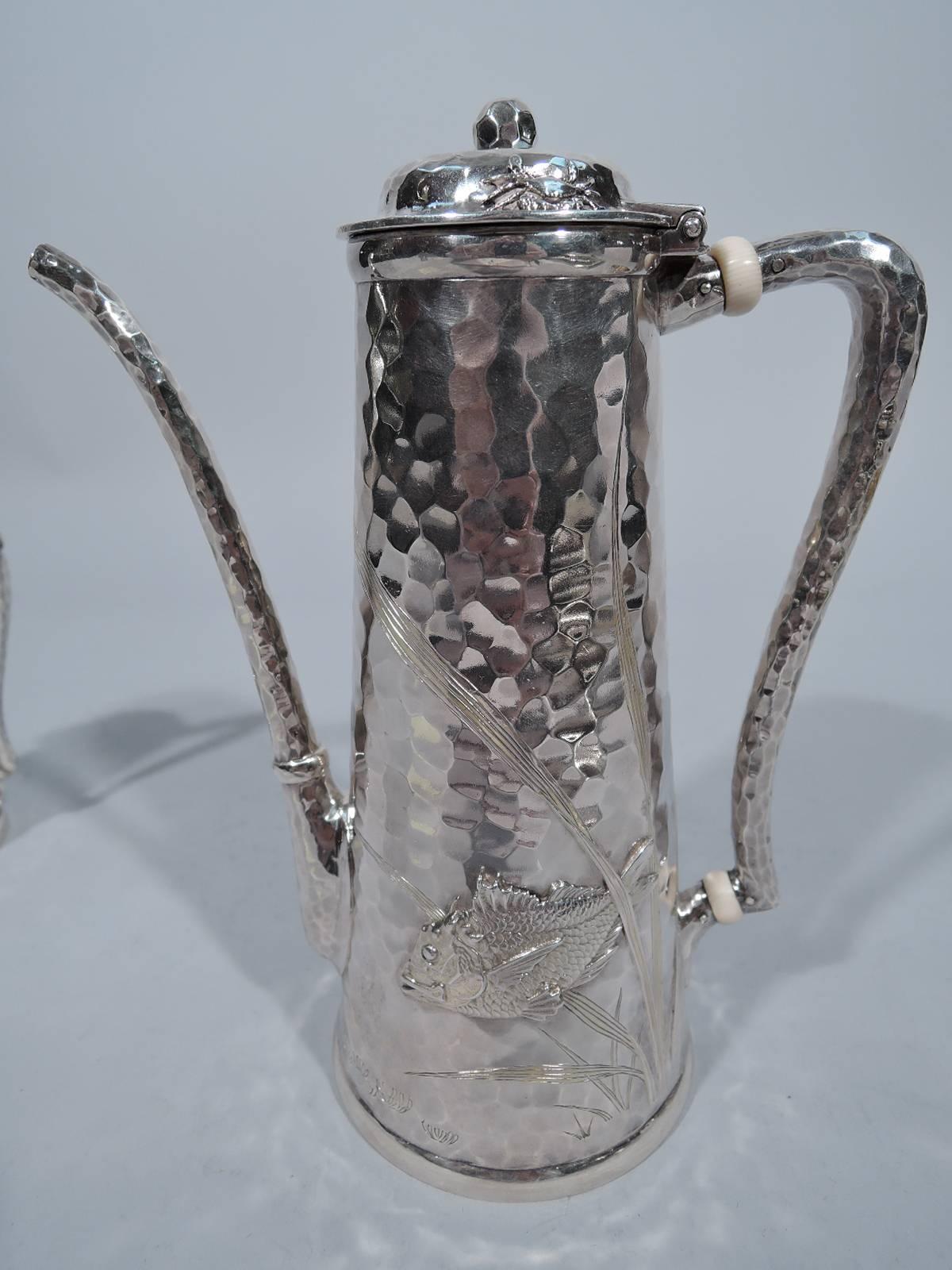 Hand-hammered and applied sterling silver coffee set. Made by Tiffany & Co. in New York, circa 1880. This set comprises coffeepot, creamer and sugar.

Japonesque marine life heightened with gilt wash applied to honeycomb ground: fish and crabs