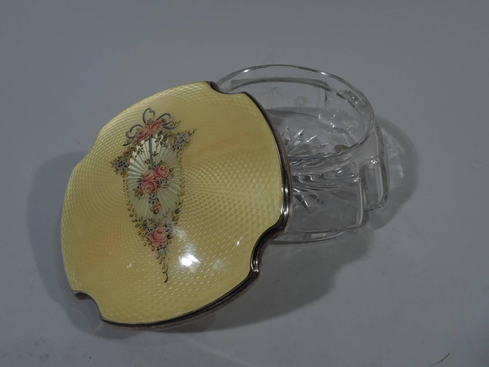 Edwardian clear glass powder jar with sterling silver and enamel cover. Made by Thomae in Attleboro, Mass., circa 1920. Jar has four curved and upward sides with concave corners. Garlands acid-etched on sides and star cut to bottom. Cover top has
