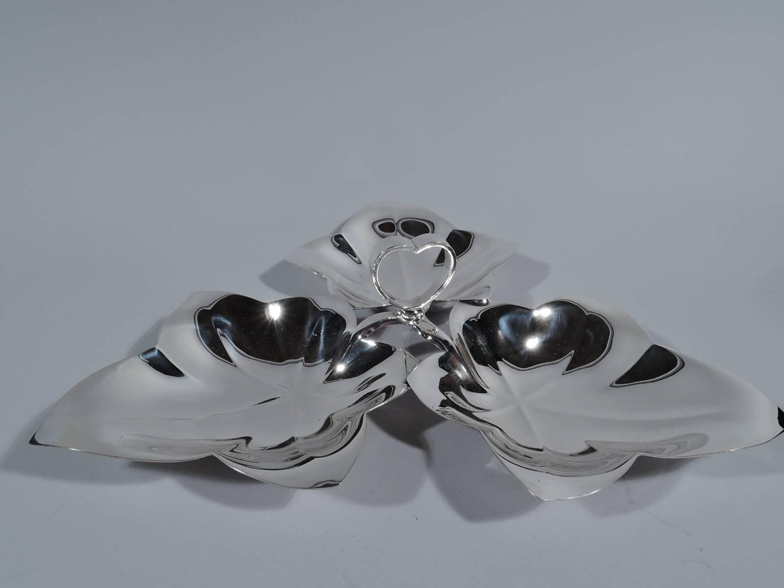 Midcentury sterling silver three-leaf condiment server. Made by Tiffany & Co. in New York. Three veined five-point leaves joined at stem with open heart handle. A playful, informal design by the dowager duchess of American silver. Hallmark includes