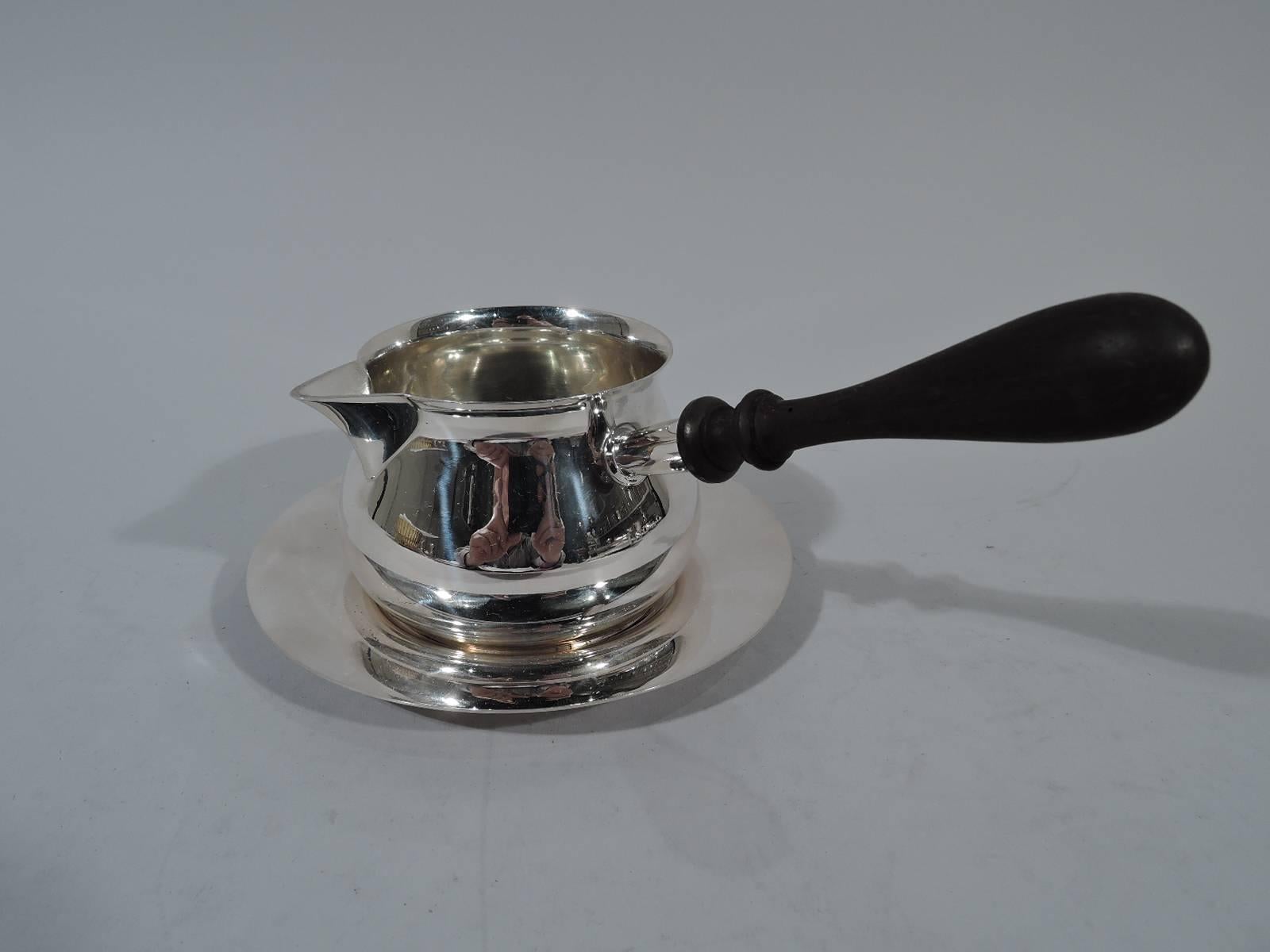 Georgian Sterling silver pipkin on Stand. Made by Tuttle in Boston in 1953. Pipkin: Curved and upward tapering bowl with sharp v-spout and stained-wood baluster handle. Stand: Circular with well. Hallmarks include no. 142 and presidential date code.
