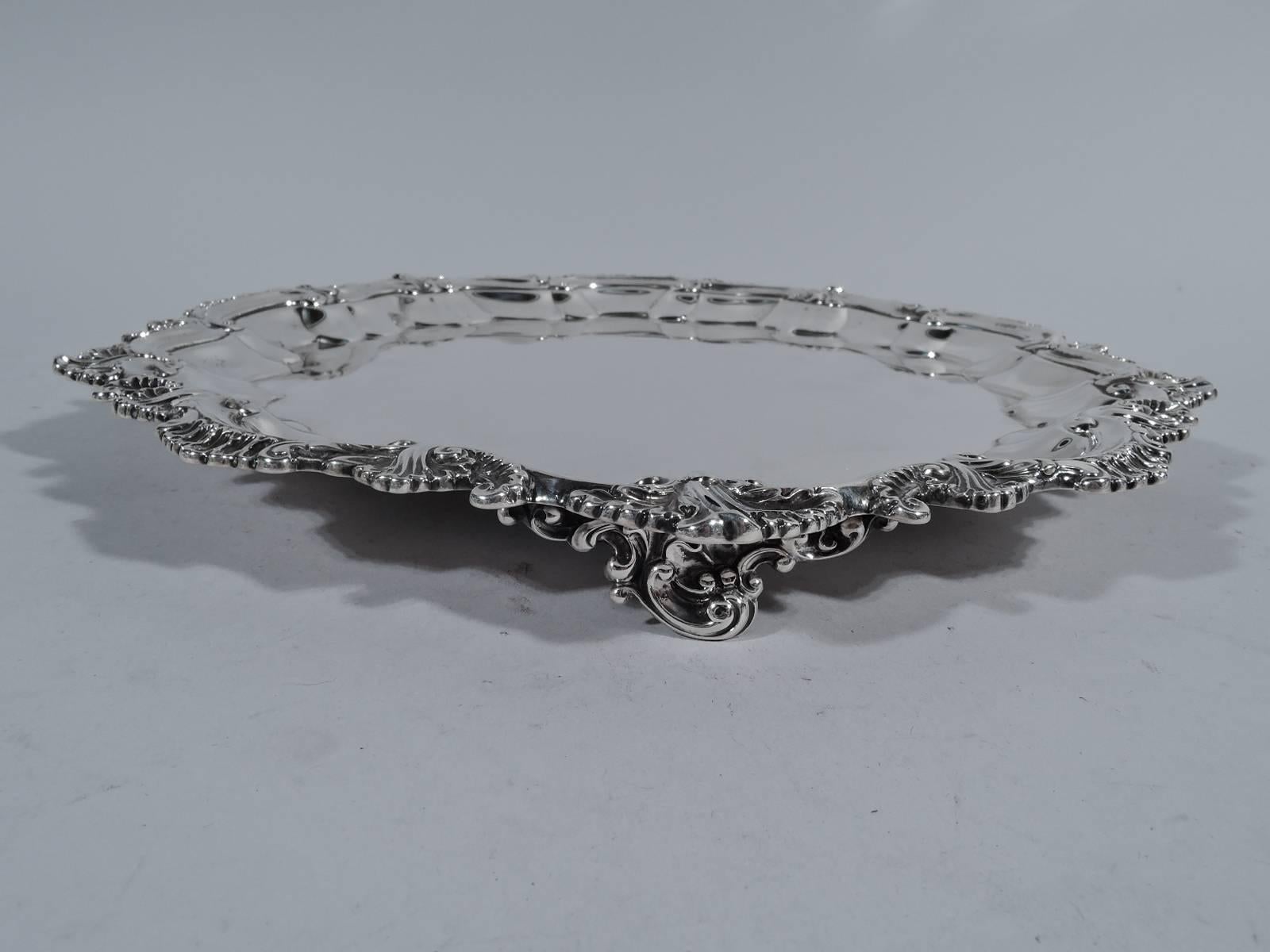 Fancy Georgian Revival sterling silver salver. Made by Shreve, Crump & Low in Boston, circa 1900. Molded rim with shells and leaves. Rests on three scrolled supports. Hallmark includes no. 298. Weight: 17.5 troy ounces.