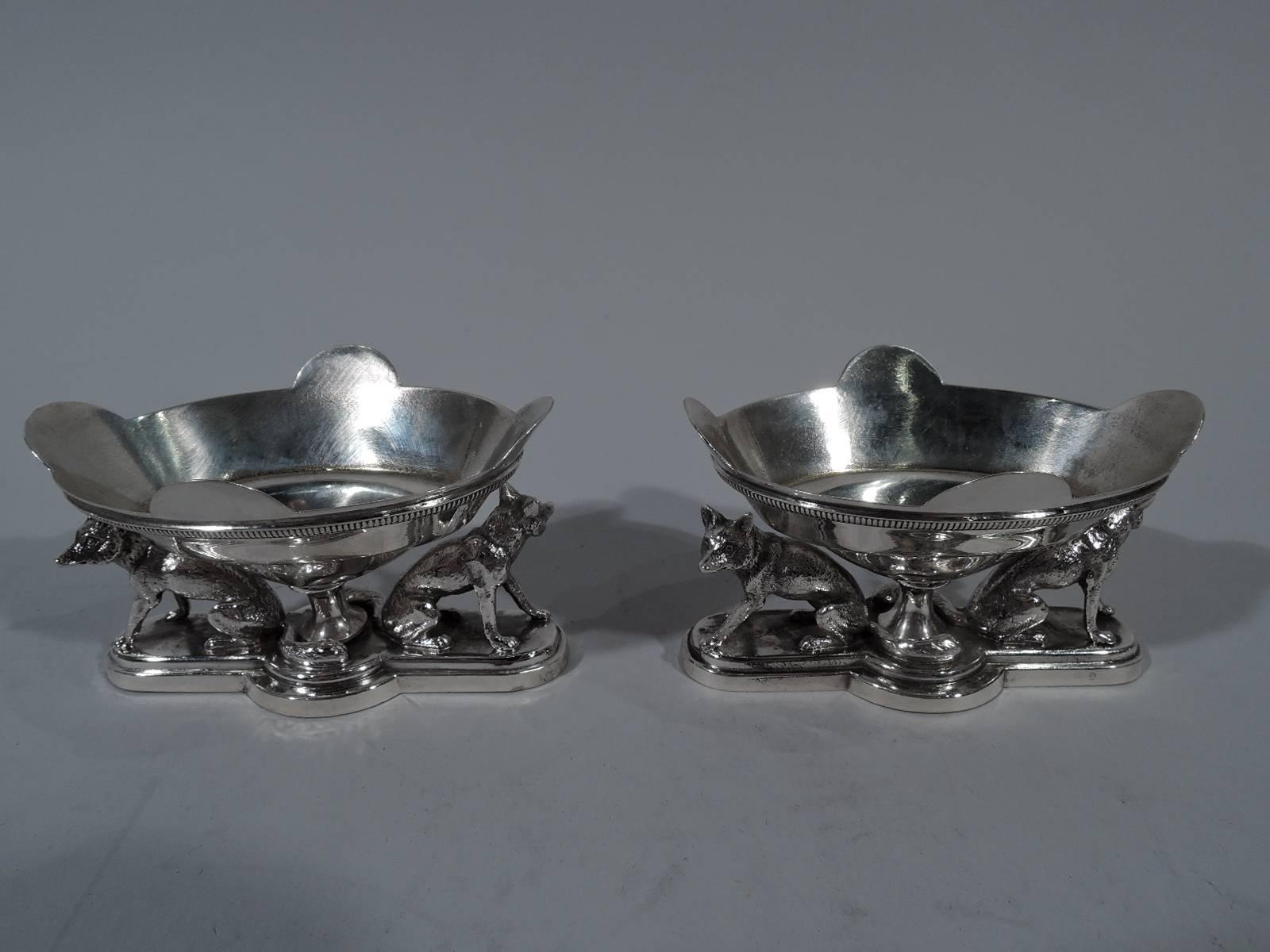 Pair of rare and wonderful coin silver open salts. Made by Gorham in Providence, circa 1860. Each: Ovoid bowl with four scallops and raised circular foot mounted to stepped quatrefoil base. On base are two cast fox figures, seated on haunches with