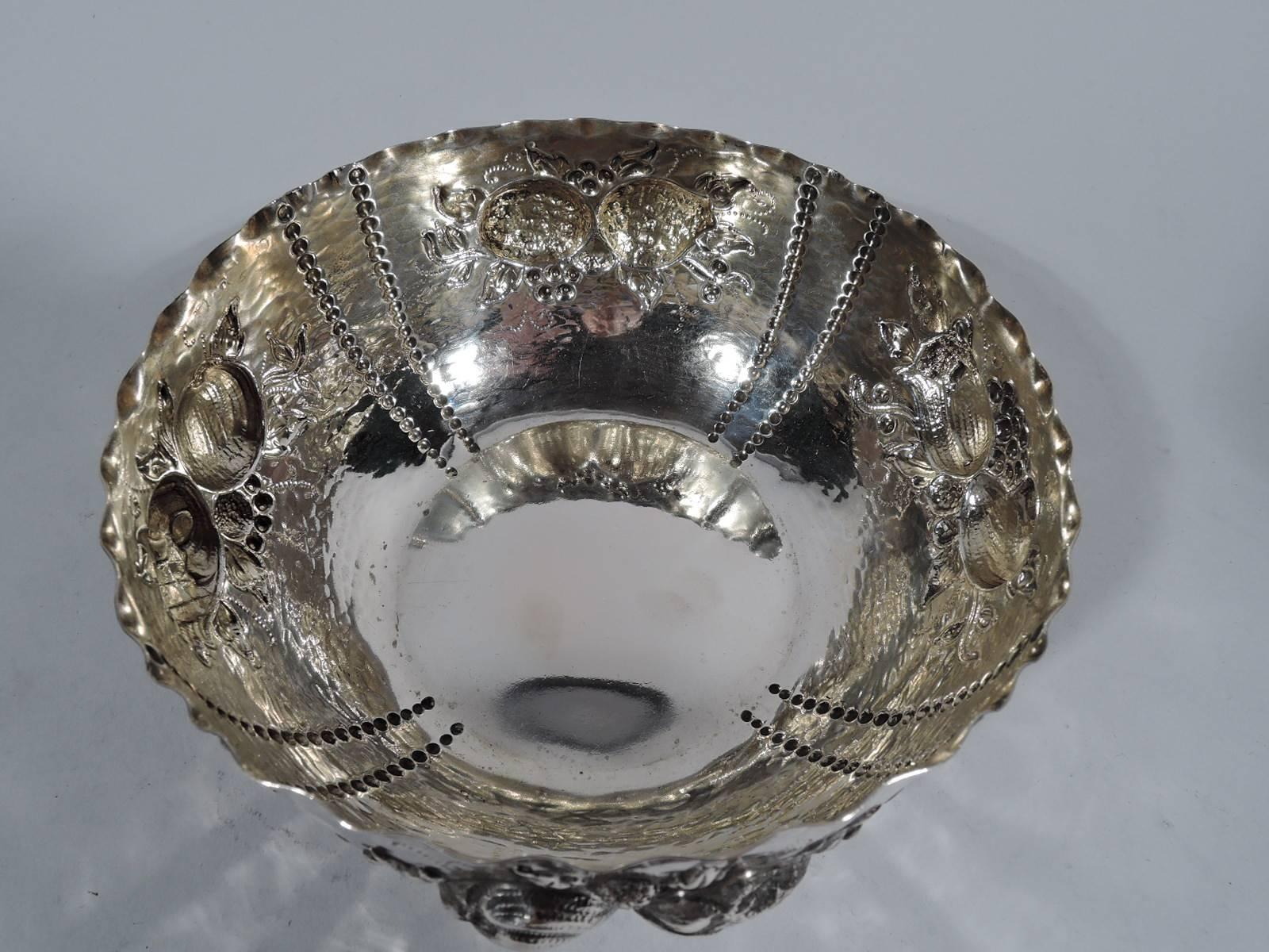 Swedish naïve-style 830 silver bowl. Made by CG Hallberg in 1914. Curved sides with repousse ornament: Fruits and berries between double beaded rows. Crimped rim and visible hand hammering. An accomplished country design by the established Stockholm