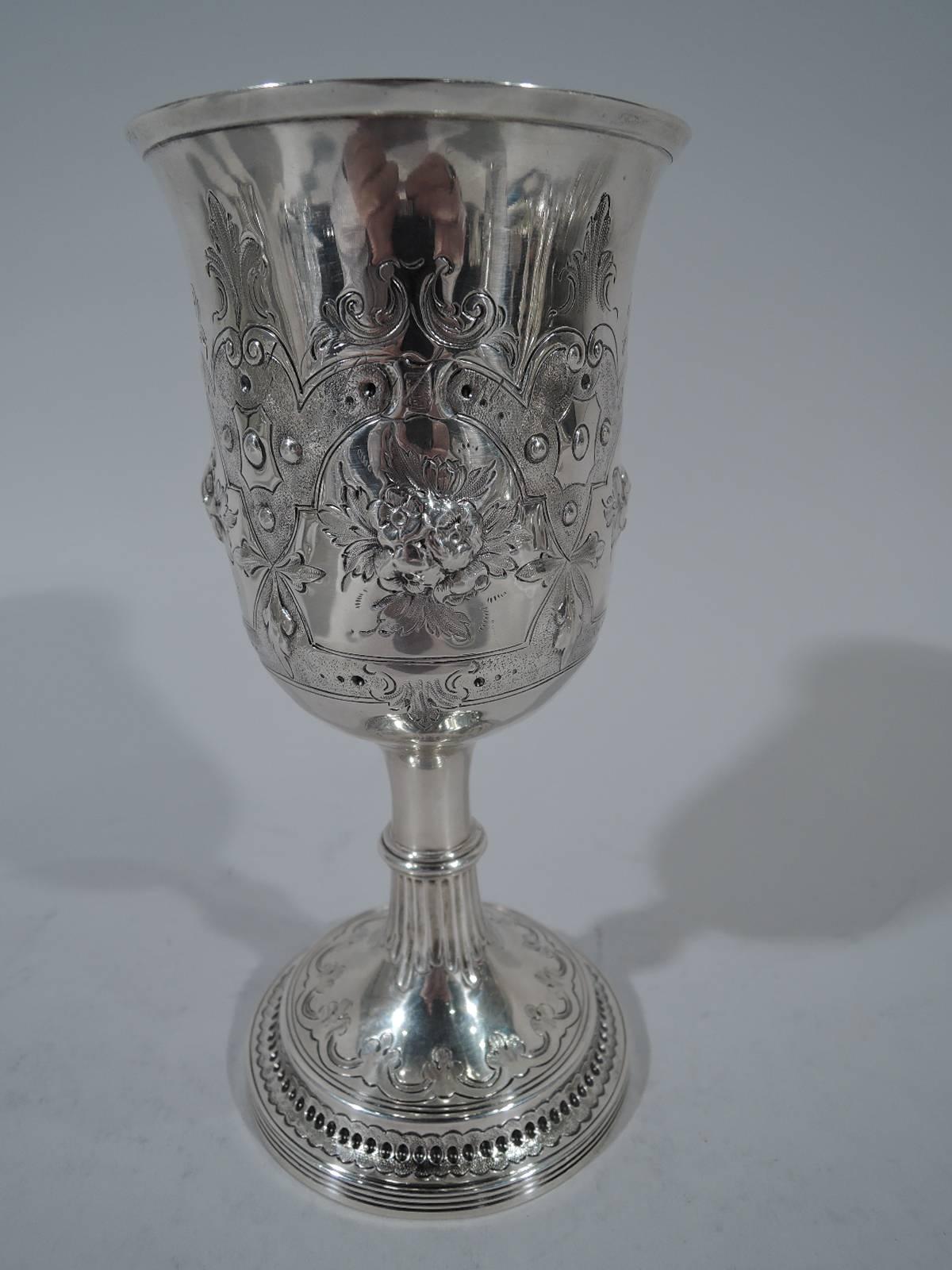 George-III sterling silver goblet. Made in London in 1805. Flared and applied rim, knapped and fluted stem, and domed and reeded foot. Fine Georgian form with chased and engraved ornament: Stippled strapwork frames inset with posies. One frame