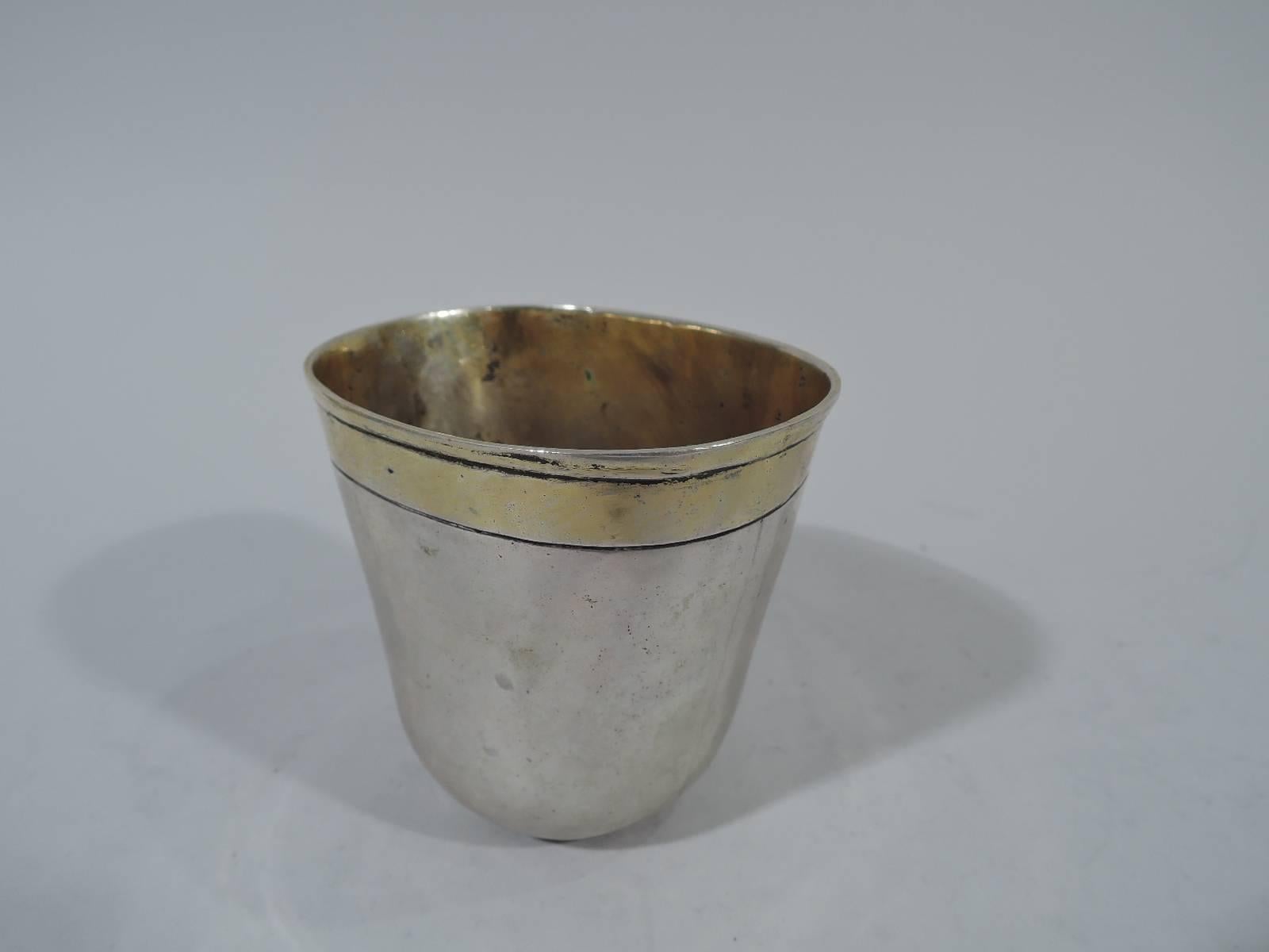 German silver beaker, 18th century ovoid with slightly flattened form. Rim has incised and gilt band. A beautiful piece rich in history. Nuremberg hallmark. Weight: 4.5 troy ounces.