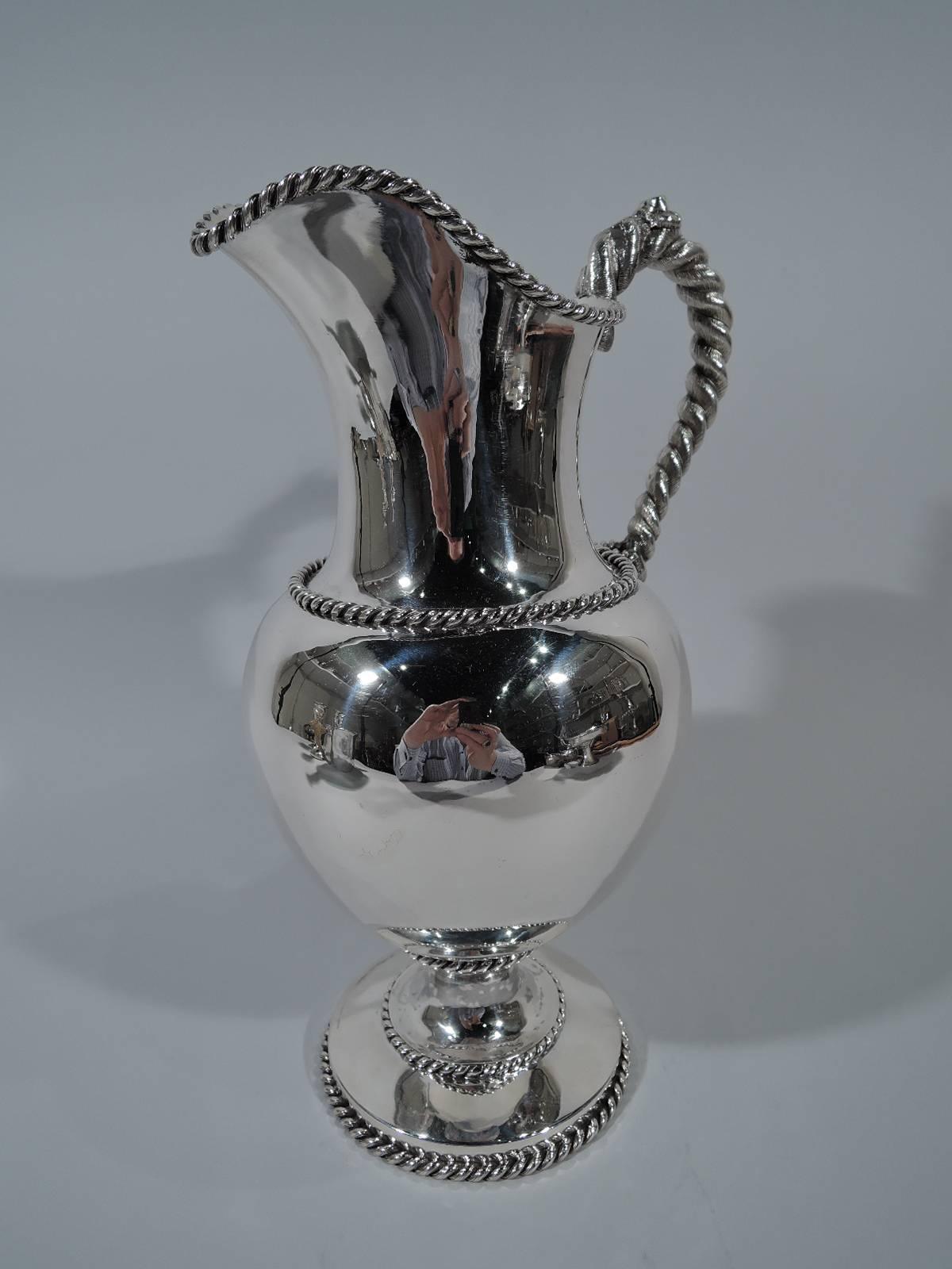 Nautical coin silver water pitcher. Made by William Gale in New York, circa 1860. Ovoid body with round stepped foot and helmet mount. Cable applied to rims, foot, and body. S-scroll handle in form of thick and coarse rope. A fine and functional
