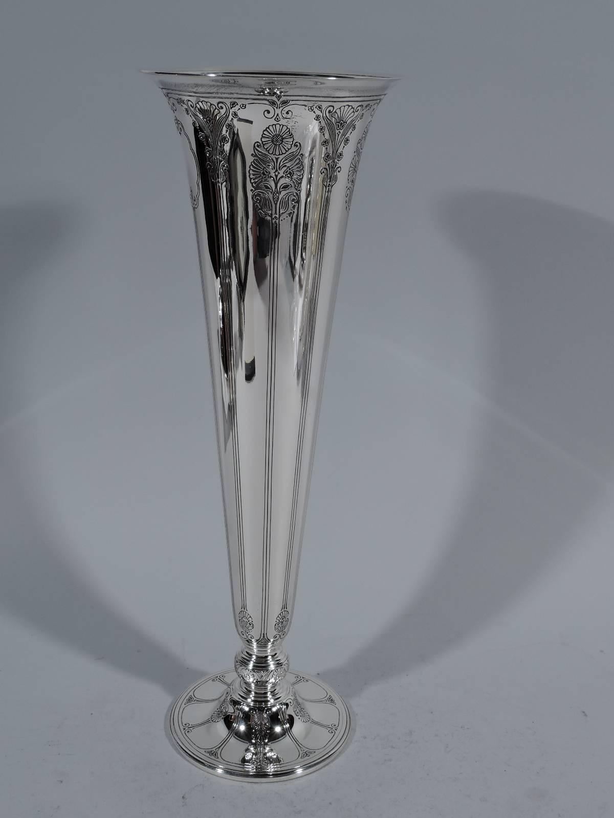 Art Deco sterling silver trumpet vase. Made by Tiffany & Co. in New York, circa 1921. Tapering sides and flared rim on knop on raised circular foot. Elongating vertical ornament: Stylized flowers as well as lines and scrolls. Scalloped frame