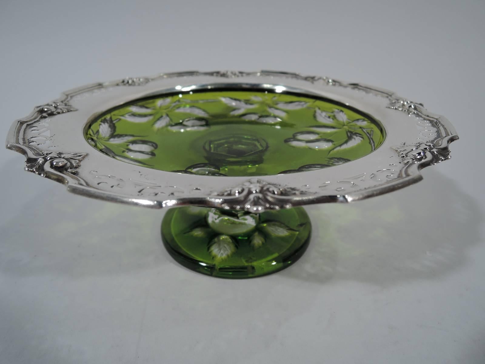 Pair of Edwardian sterling silver and cut-to-clear glass compotes. Made by Gorham in Providence in 1907. Each: Shallow bowl, short faceted stem, and flat circular foot. Olive glass with cut-to-clear cherries. Sterling silver rim with applied