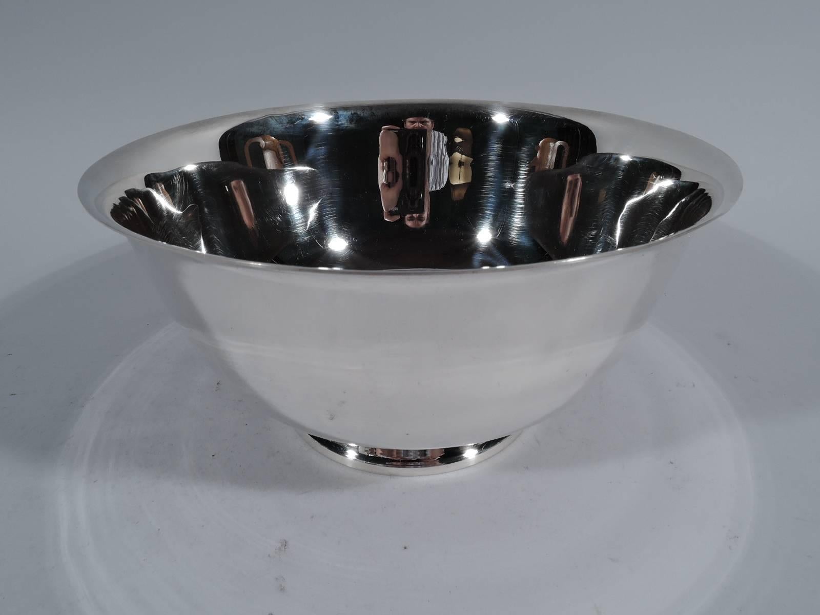 Traditional sterling silver Revere bowl. Made by Tiffany & Co. in New York. Curved sides with flared rim and stepped feet. Fine form with plenty of room for engraving. Hallmark includes postwar pattern no. 23618. Weight 18.6 troy ounces.