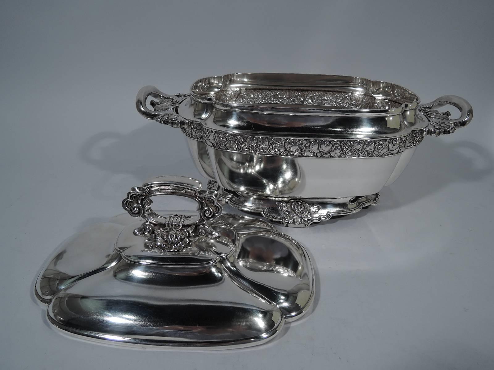 Chinese-style sterling silver tureen. Made by Tiffany & Co. in New York, circa 1877. Lobed body with open end handles and spread base on 4 volutes. Cover domed and lobed with open handle. Chinese ornament including clouds, rooster heads, and