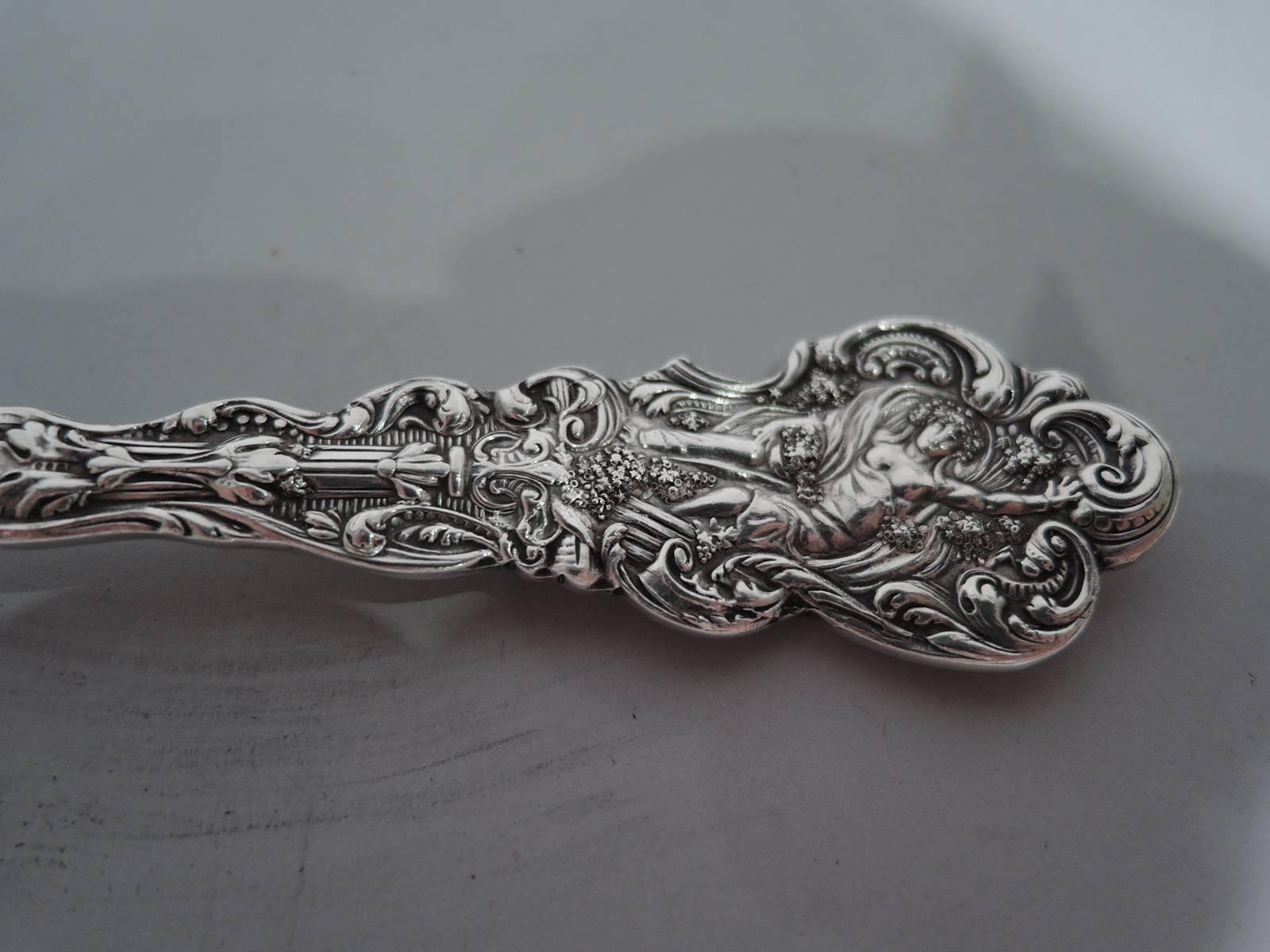 Sterling silver tomato server in Versailles pattern. Made by Gorham in Providence. Scrolled terminal with Classical Baroque figure and ornament. Circular blade with ornamental piercing. A really nice serving piece in this historic pattern, which was