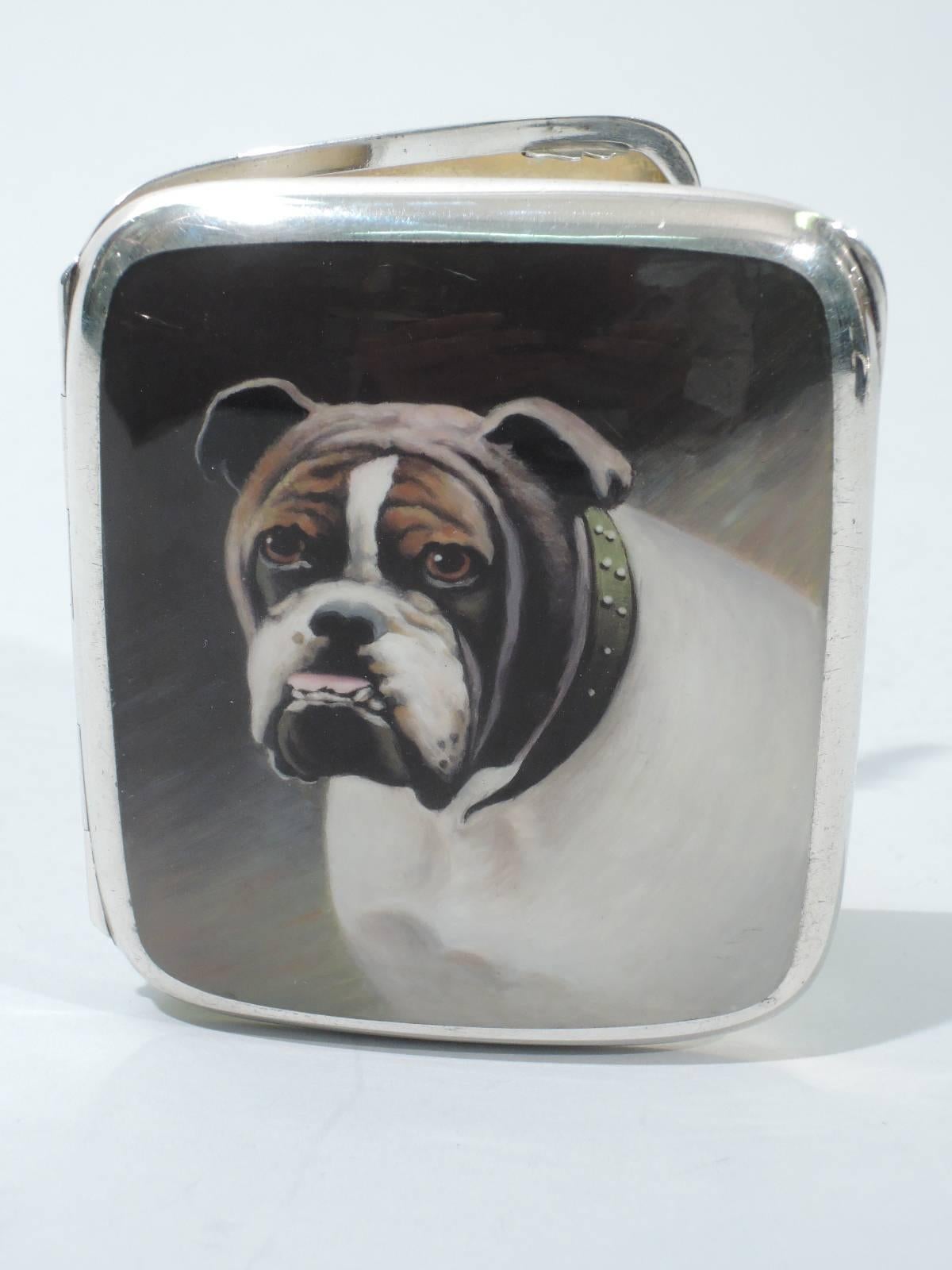 European cigarette case in 900 silver and enamel, circa 1910. Rectangular with curved corners and hinged cover. On cover is enameled bust of English bulldog: sagging jowls, pink tongue, and anxious brown eyes. Around neck is studded green collar.