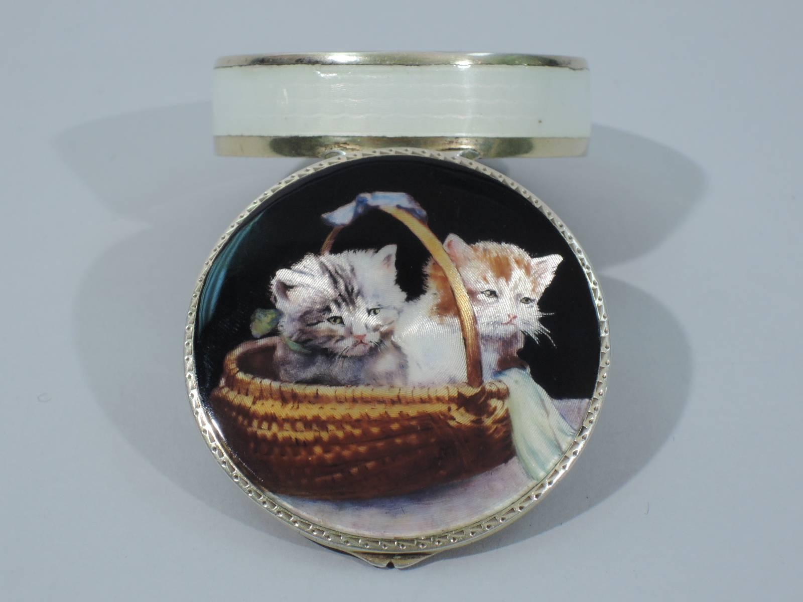 Antique silver gilt and enamel compact with cats in a basket. Round with flat and hinged cover. On cover two kittens cuddle in beribboned basket. They have pink noses, whiskers, and lots of soft fur. They're real fluff balls. Color heightened by