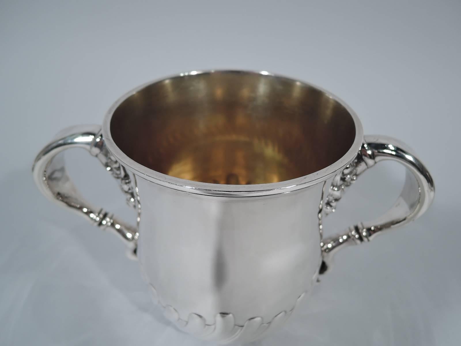 Sterling silver trophy cup. Made by Bigelow, Kennard & Company Inc. in Boston, circa 1900. Urn with scroll-mounted scroll handles and twisted fluting at base. Gilt interior. Traditional and substantial with room for engraving. Hallmarked. Heavy