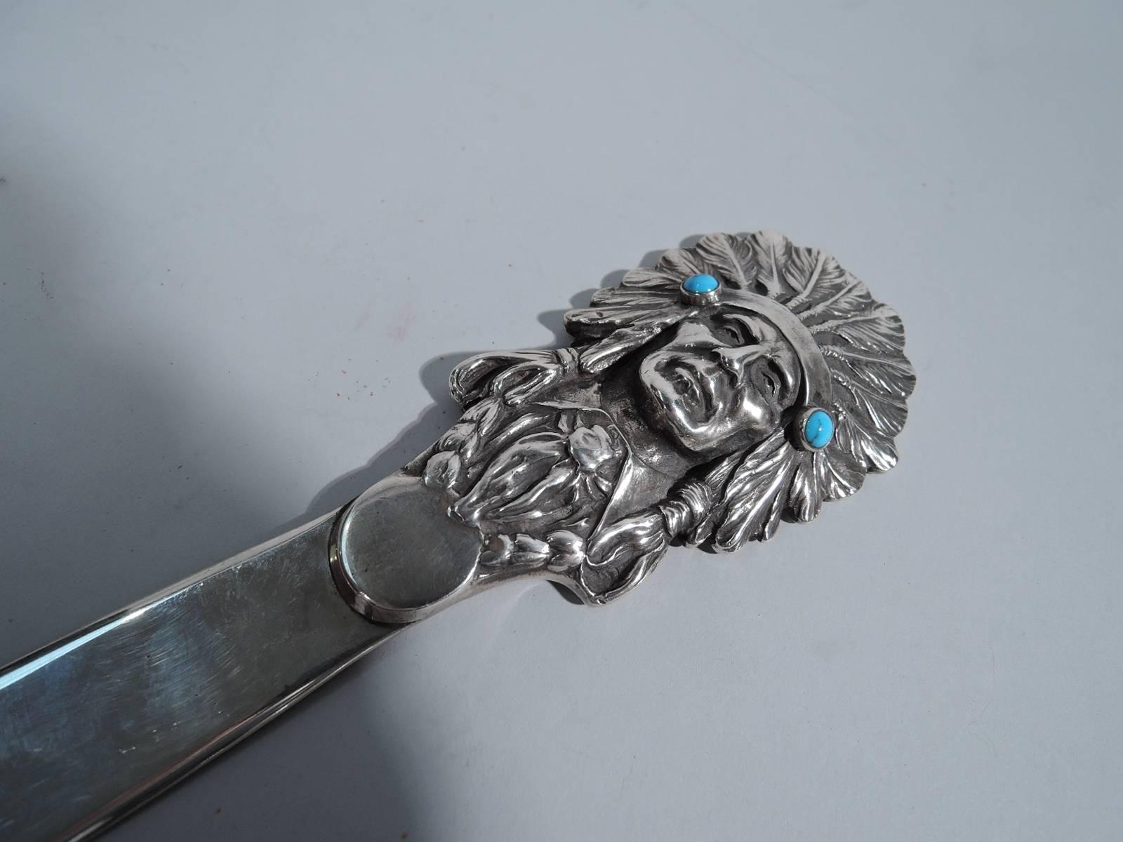Western sterling silver letter opener. Made by Edward H Bohlin in Hollywood, circa 1930. Cast Indian Chief terminal with feathered headdress embellished with cabochon turquoise beads. On back interlaced script monogram. A great piece by Bohlin, who