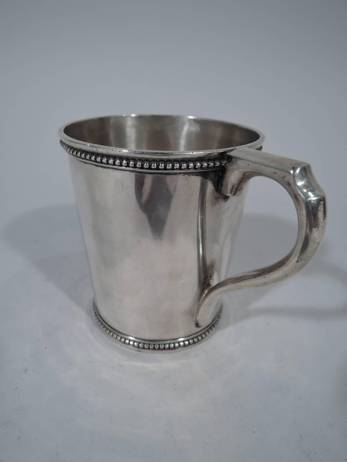 Coin silver christening mug. Straight and tapering sides, beaded rim and foot and scroll bracket handle. A sweet piece that awaits the name of a 21st century newborn. Hallmarked Newell Harding, a Boston maker active in the first half of the 19th