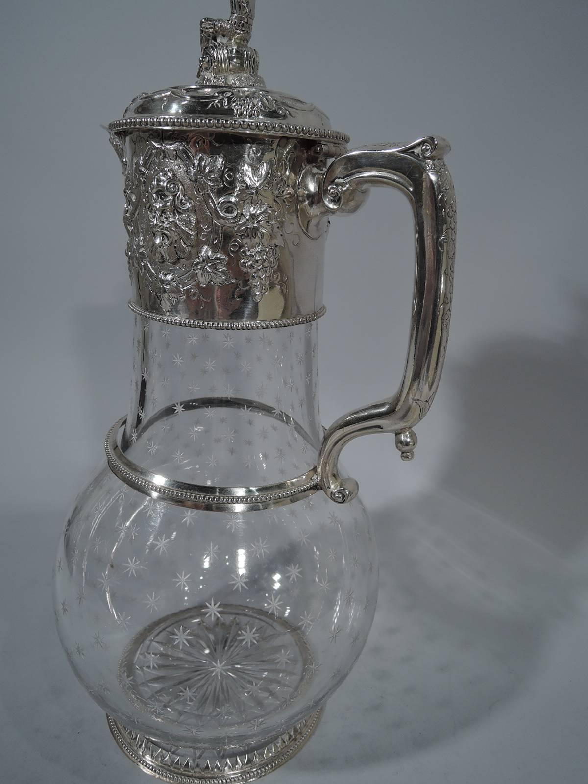 Victorian crystal decanter with sterling silver mounts. Made by John Newton Mappin & George Webb in London in 1869. Globular body with upward tapering neck and flat circular foot. All-over acid-etched stars plus one cut to foot underside. Silver