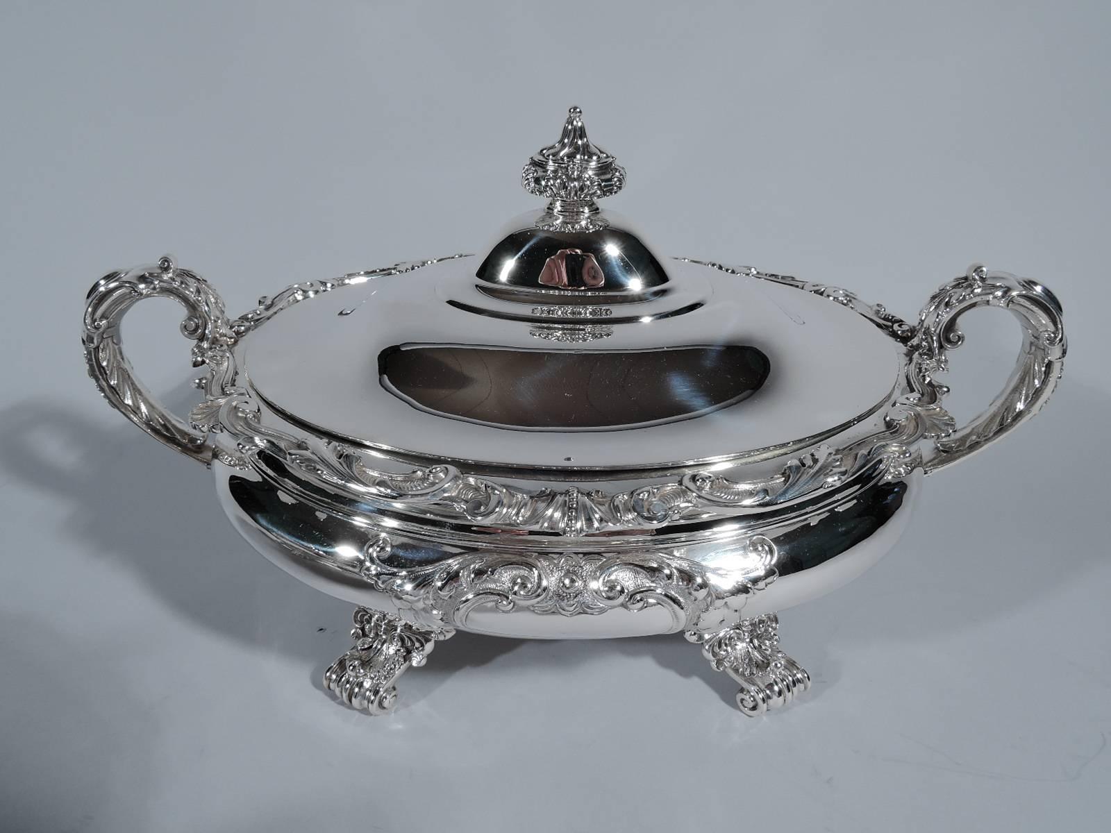 Beautiful pair of sterling silver covered vegetable dishes. Made by Gorham in Providence, circa 1910. Each: Bellied bowl, scrolled end handles, and four exquisitely formed scrolled supports with shell and leaf mounts. Rim decorated with applied