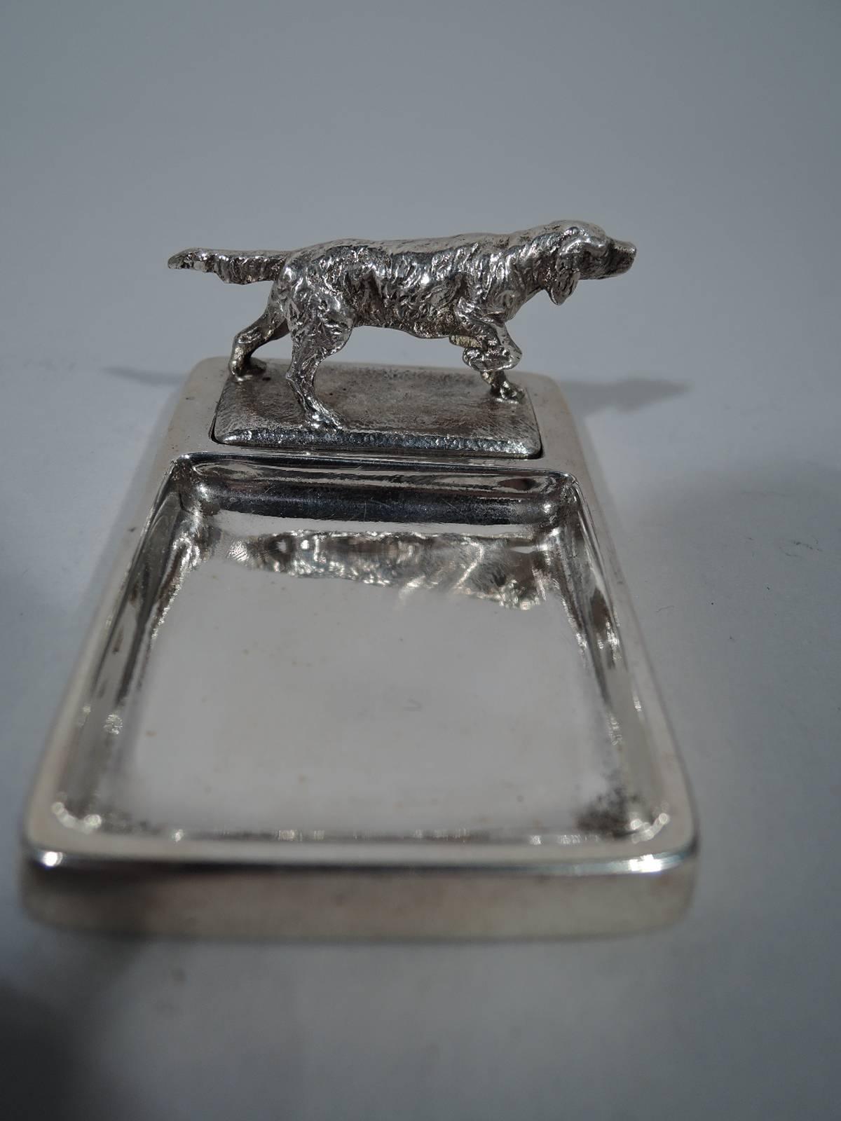 Sterling silver vide-poche. Made by Tiffany & Co. in New York, ca 1931. Rectangular base with square well. Cast retriever with raised paw and erect tail. Figure mounted to grassy ground set in rectangular well. A fine breed specific piece. Hallmark