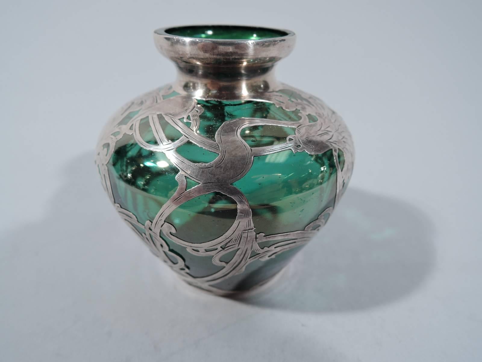 Art Nouveau emerald green glass bud vase with silver overlay. Made by La Pierre (part of International) in Newark, circa 1900. Ovoid body with short neck in silver collar. Entwined and whiplash floral overlay heightened with engraving. Scrolled