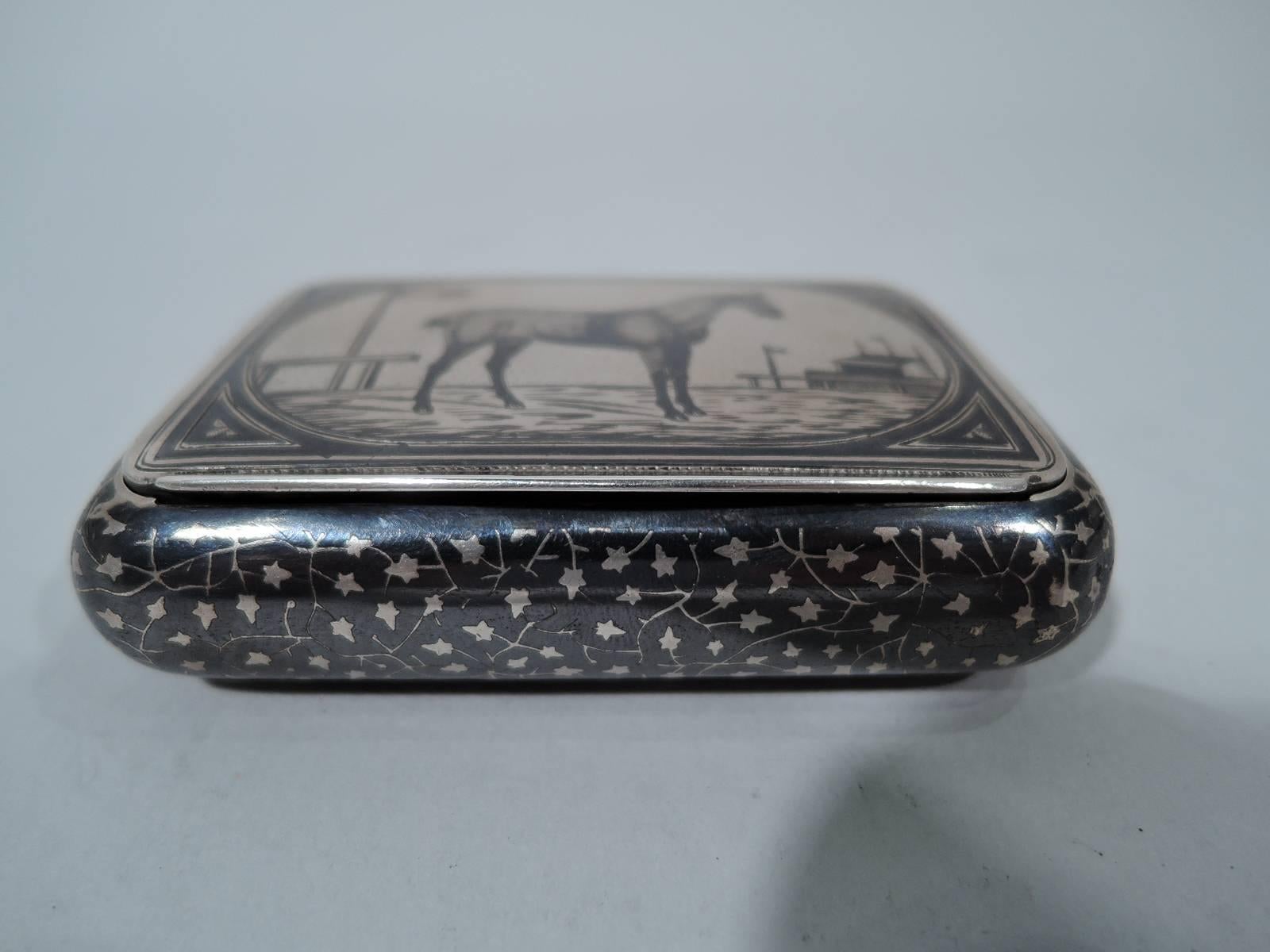 Austrian 900 silver snuffbox, circa 1880. Rectangular with curved sides. Cover hinged and tabbed. Niello ornament. On cover standing racehorse with pennants and stadium in background. Sides and bottom have stylized repeating leaf pattern. Hallmark