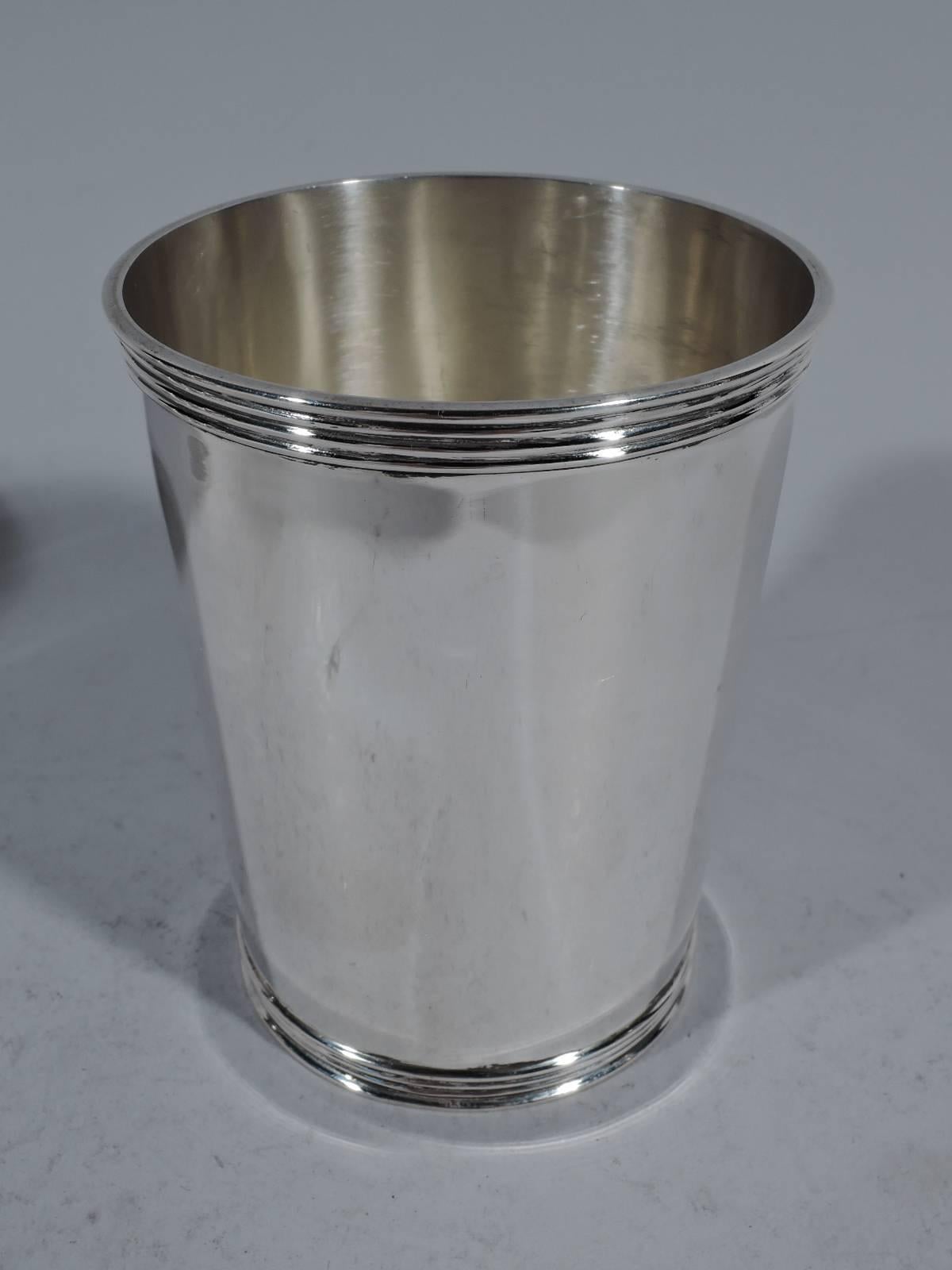 Set of four sterling silver mint juleps. Made by Manchester in Providence. Straight and tapering sides and reeded rim and foot. A great starter set. Hallmark includes no. 3759. Total weight: 15.2 troy ounces.
