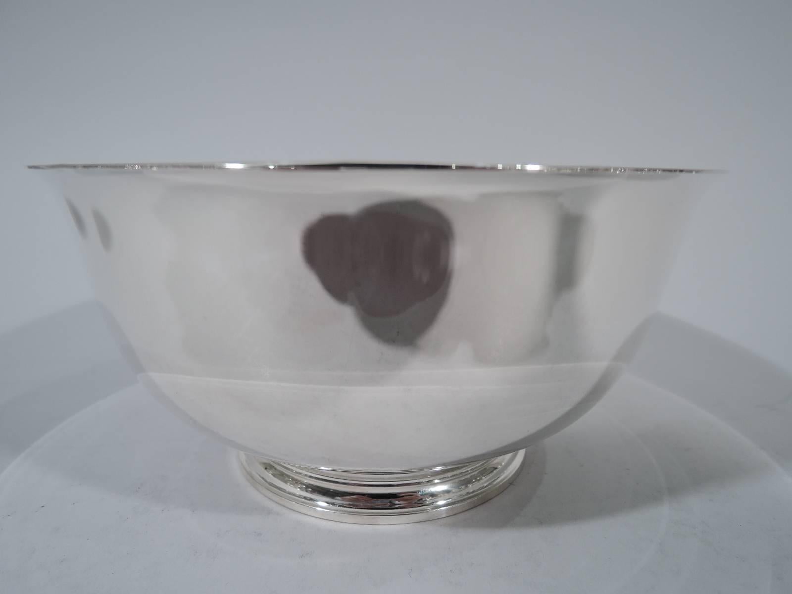 Sterling silver Revere bowl. Made by Tiffany & Co. in New York. Curved sides, flared rim, and stepped foot. A nice trophy with plenty of room for engraving. Hallmark includes postwar pattern no. 23616. Weight: 12.2 troy ounces.