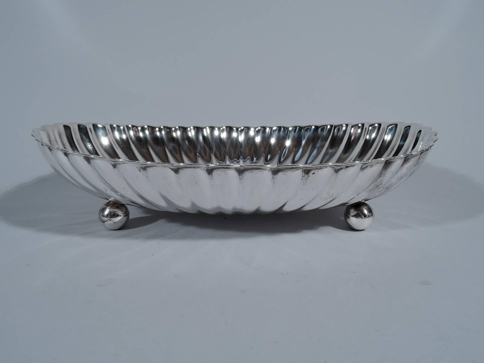 Sterling silver bowl in Leamington pattern. Made by Gorham in Providence, circa 1940. Oval with concentric lobing. Rests on four balls. Hallmark includes pattern name and no. 42603. Heavy weight: 15 troy ounces.