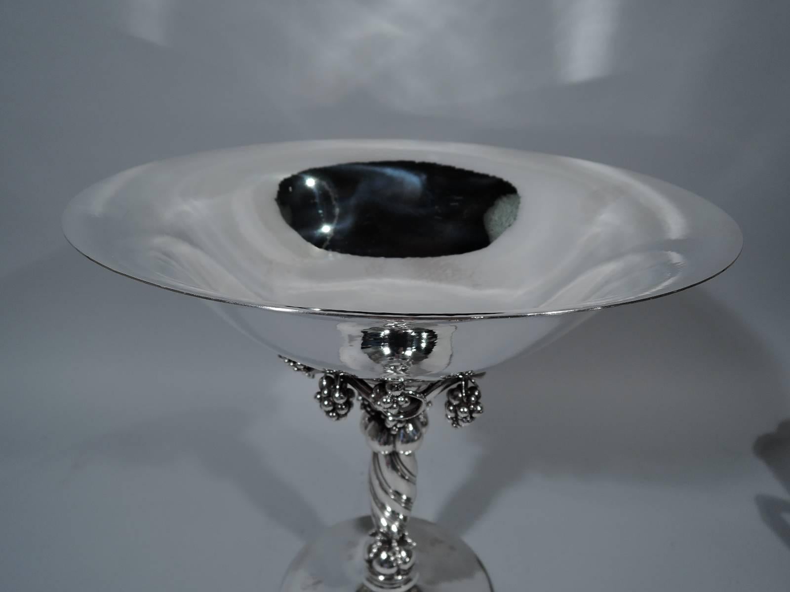 Tall sterling silver grape compote. Made by Georg Jensen in Copenhagen. Curved bowl on twisted shaft on raised foot. Fruiting grapevine with fixed bunches mounted to bowl underside. Shaft has lobed knops, one with grape bunches and another with