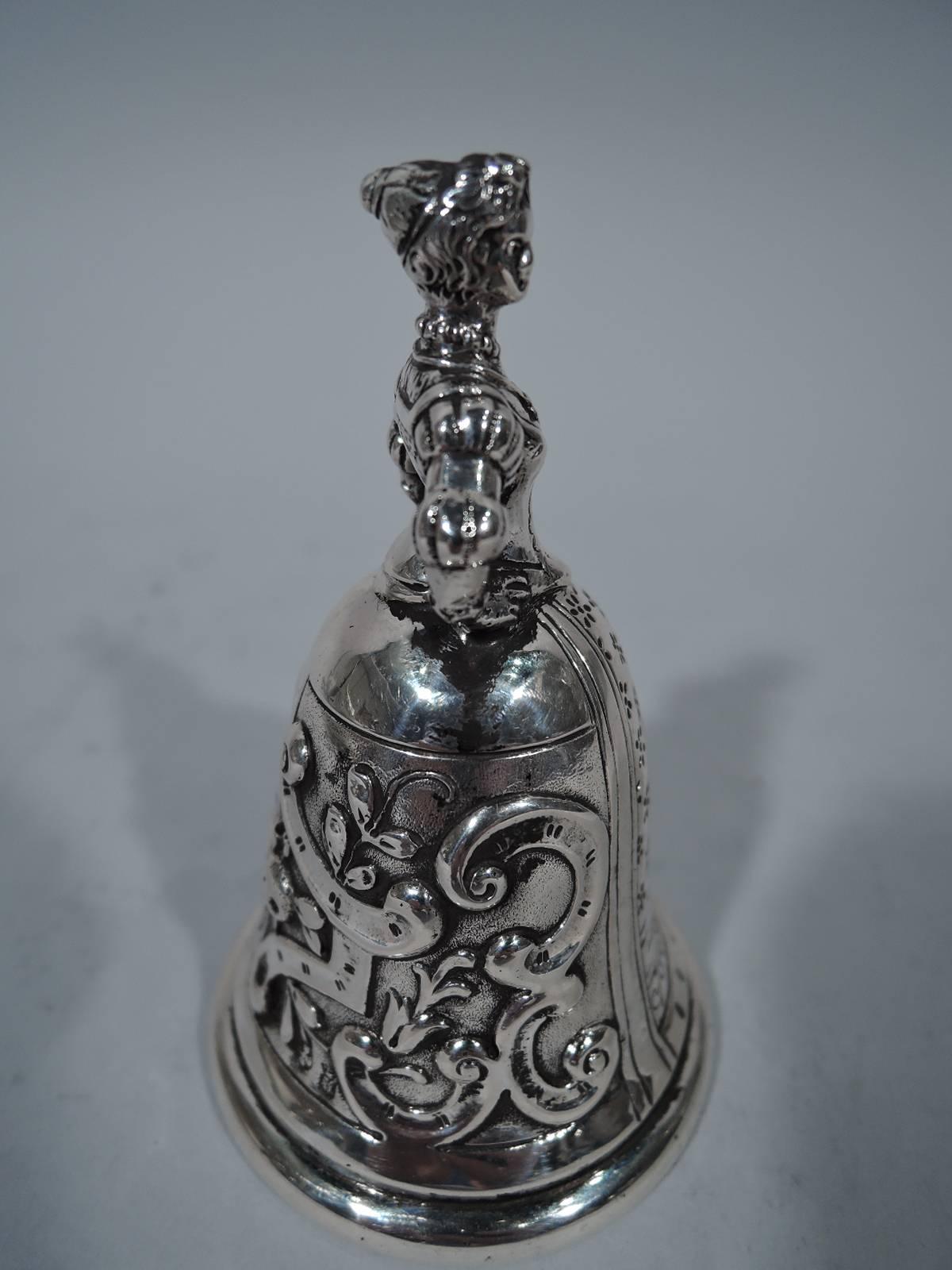 Antique European silver dinner bell. Handle in form of hands-on-hips woman in Renaissance dress with skirt-form bowl decorated with flowers and scrolls. This buxom maid is sure to bring everyone to the table. Unmarked. Weight: 2.6 troy ounces.