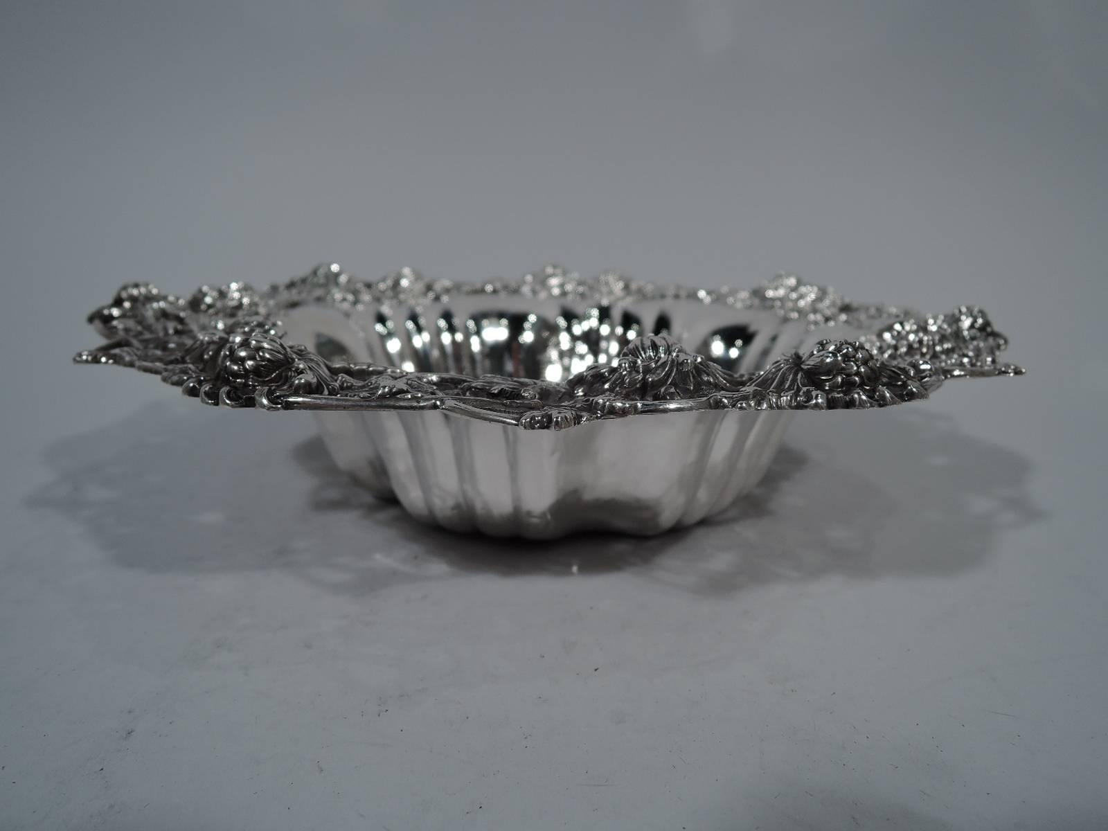 Sterling silver bowl with chrysanthemums. Made by Graff, Washbourne, & Dunn in New York, circa 1900. Tapering sides with interior fluting. Applied rim with chrysanthemums on open interlaced branches. Beautiful blossoms – a charming period motif.