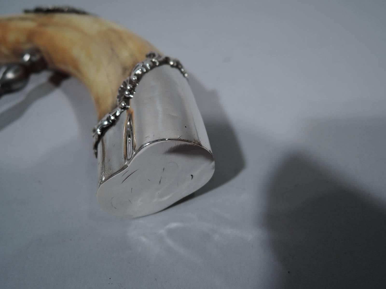 Lady’s size American sterling silver corkscrew with tusk handle, circa 1900. Tusk has sterling silver mounts with flower and shell rims. Top mount has loose ring. Makes a great belt attachment. The perfect accessory for book group night. Hallmarked