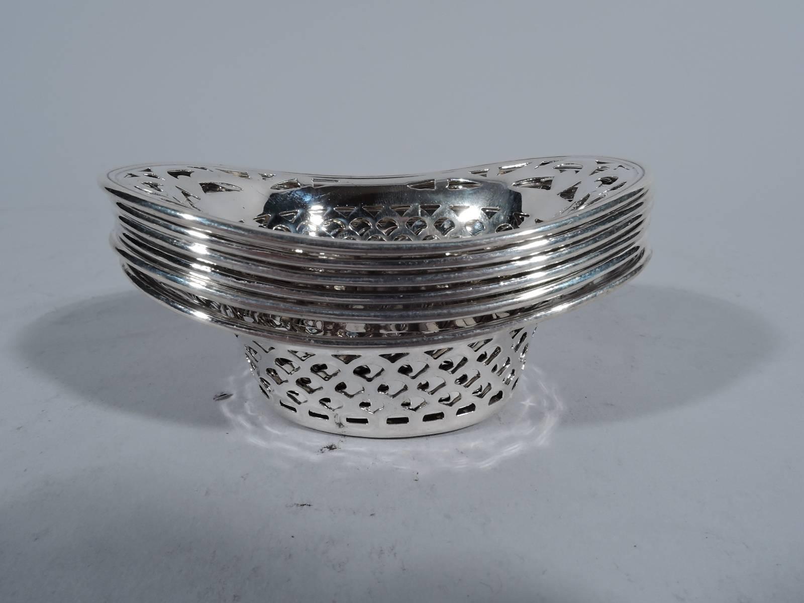 Set of six Edwardian sterling silver nut bowls. Made by Webster in North Attleboro, Mass., circa 1910. Each: Solid oval well, pierced fish scale sides and flared rim with pierced scrollwork. Monogram engraved in well. Hallmarked. Total weight: 3.4
