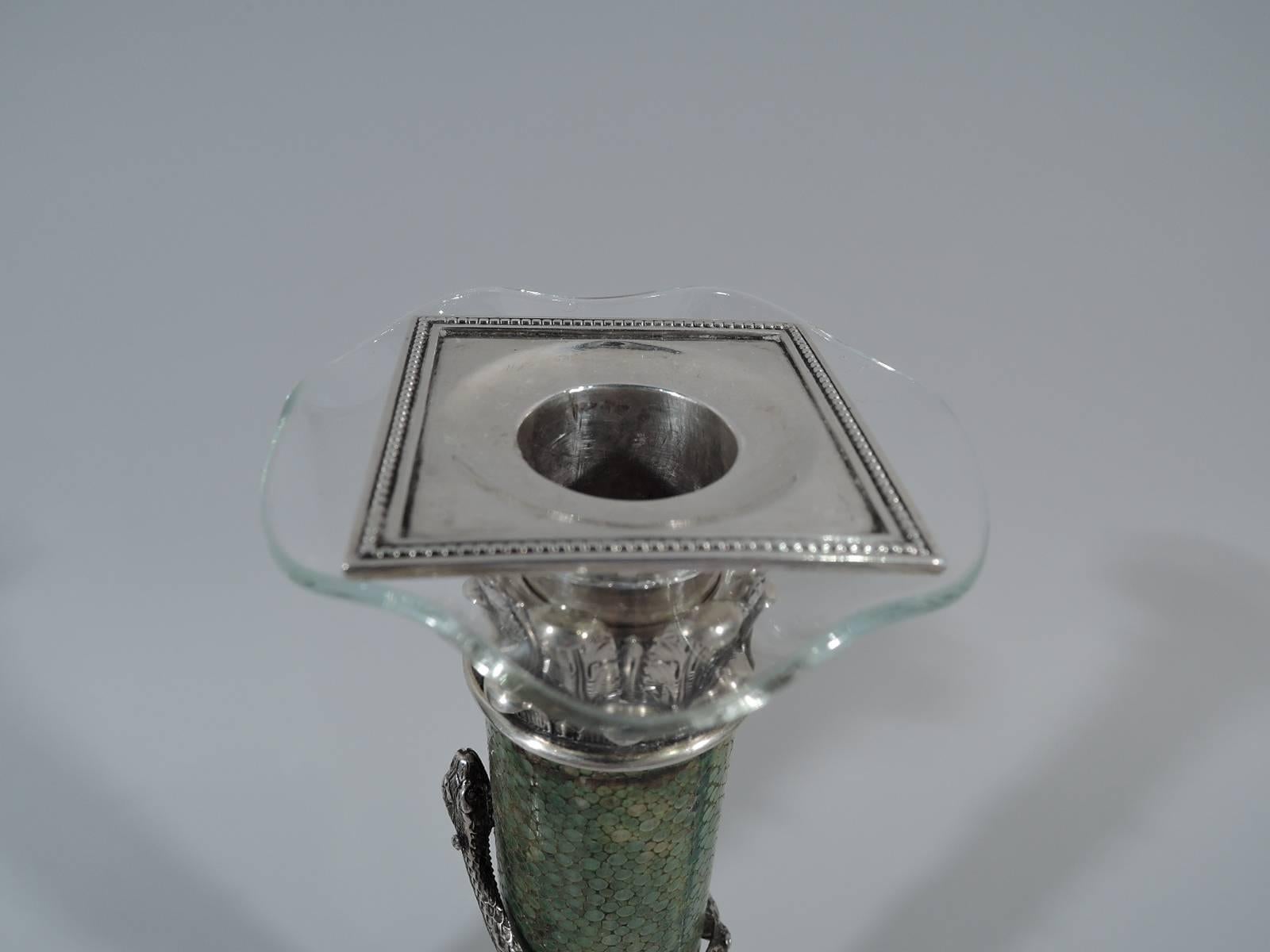 Pair of European shagreen and silver candlesticks, circa 1880. Each: Column on raised square base covered with green-tinted shagreen. Silver Corinthian capital with detachable and wavy clear glass bobeche and beaded and square silver socket. Column