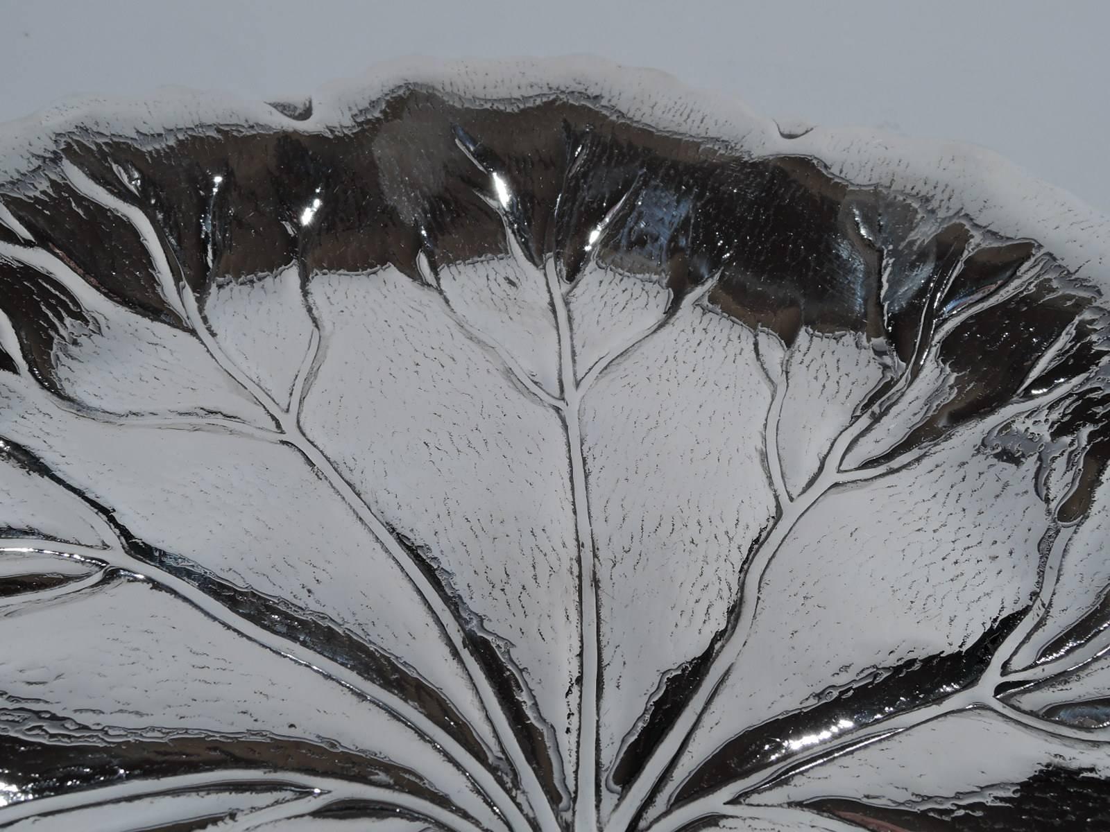 Beautiful sterling silver leaf bowl. Made by International in Meriden, Conn, circa 1950. Round with tapering sides and irregular rim. Interior veined and striated. Hallmark includes no. H125. Weight: 12 troy ounces.