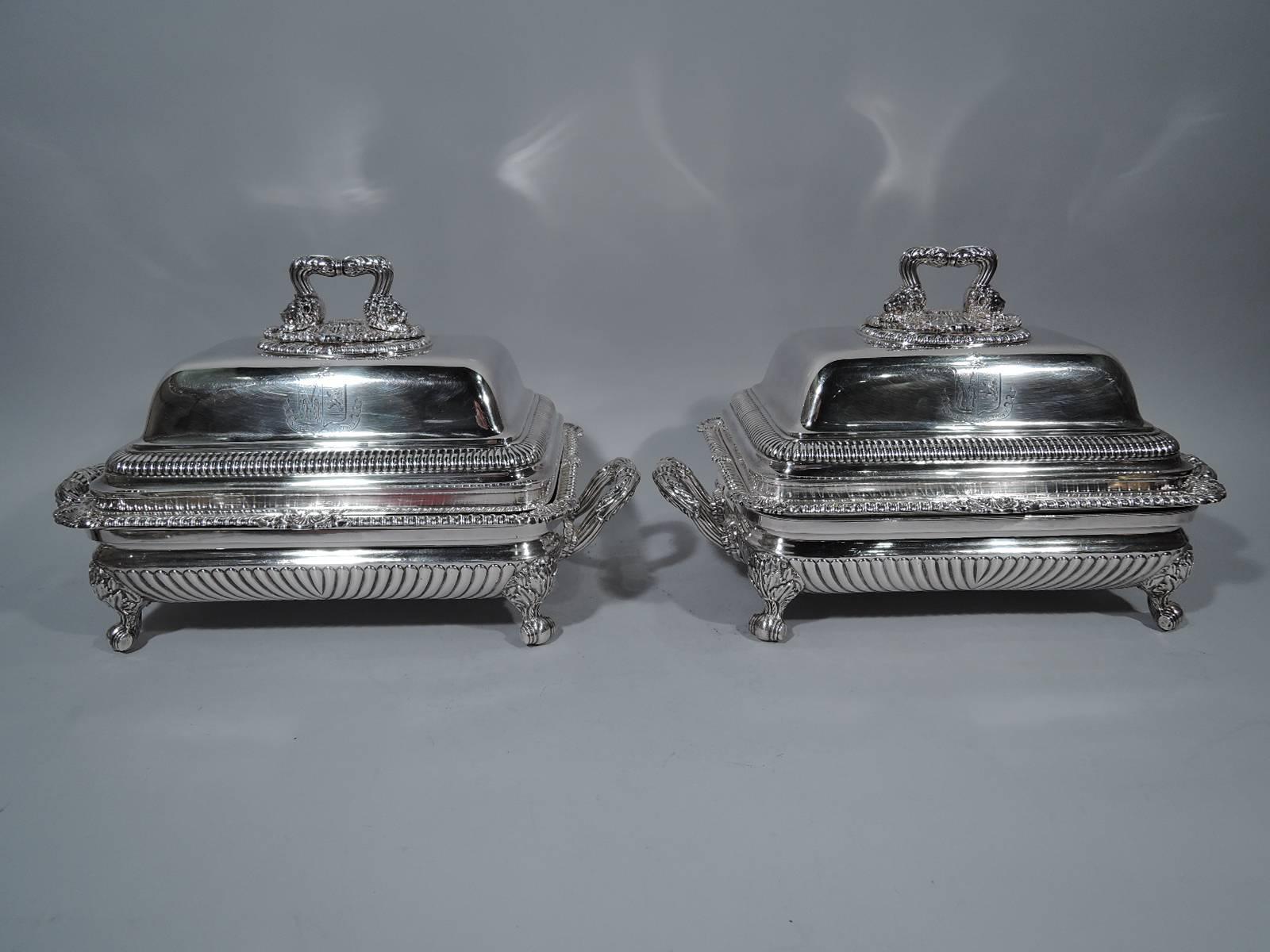 Pair of Regency sterling silver covered dishes. Made by Paul Storr in London in 1817. Each: Rectangular bowl has gadrooned rim with leaves and scallop shells. Double-domed cover has gadrooning and leaf bracket handle with lion’s heads mounted to