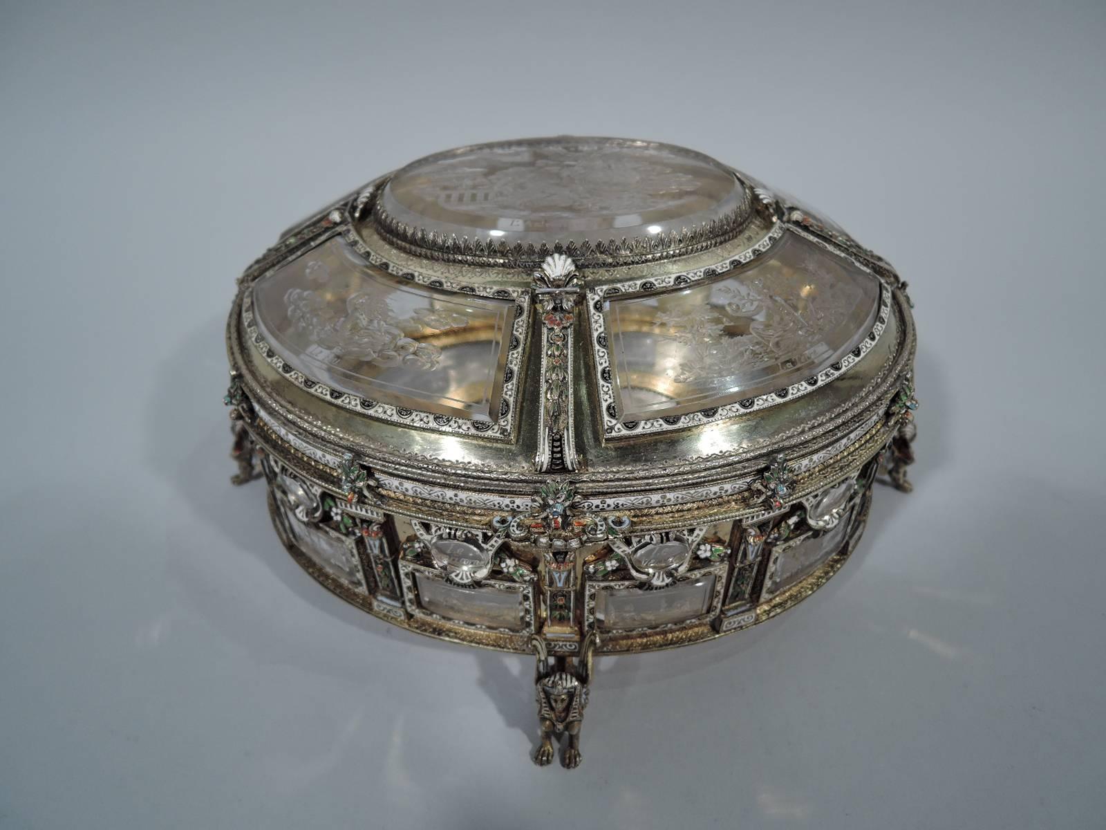 Austrian rock crystal and silver-gilt casket, circa 1880. Oval with hinged and domed cover. Silver-gilt pilaster frame heightened with enamel and bevelled rock crystal windows etched with astrological symbols and the corresponding sign in French. On