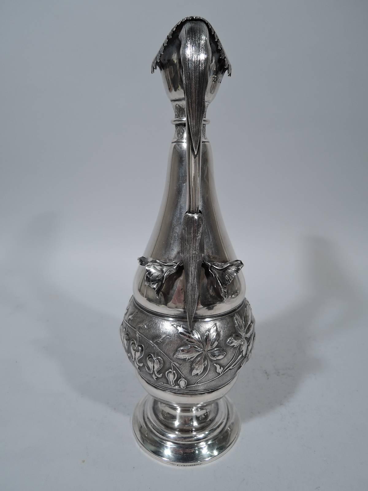 Aesthetic sterling silver decanter. Made by Frederick Elkington in Birmingham in 1886. Baluster body round stepped foot. Helmet mouth with turned-down leaves hinged flap. (Mouth interior and flap lightly gilt). Scroll handle with applied leaves and