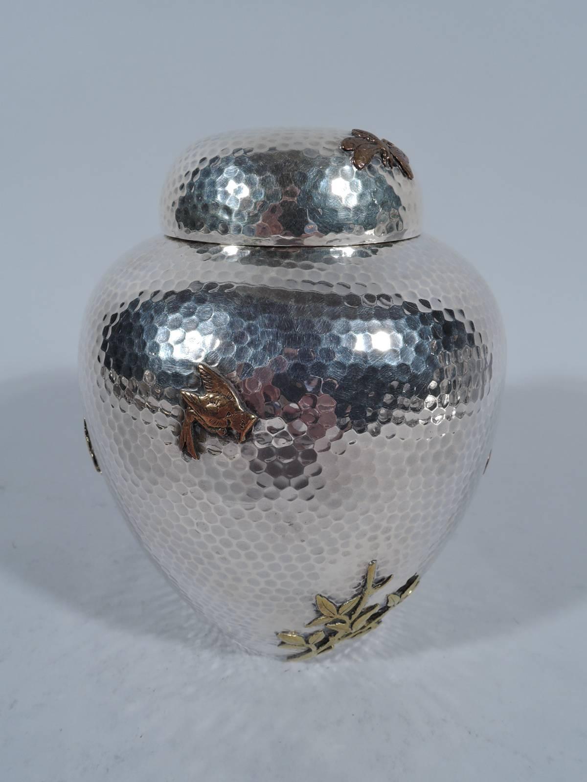Large sterling silver and mixed metal tea caddy. Made by Dominick & Haff in New York in 1879. Ginger-jar form. Honeycomb hand hammering with applied butterflies, dragonfly, birds, lizard, bamboo, and blossoming prunus branch – a veritable panoply of