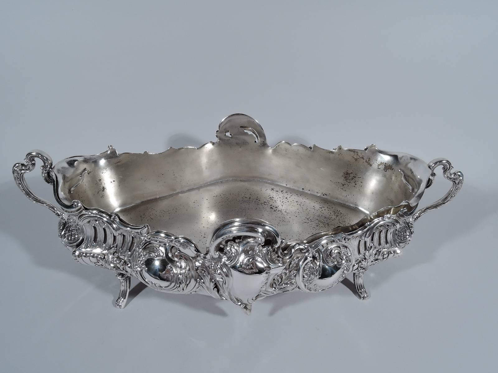 Belle Époque 950 silver jardinière. Made by V. Boivin in Paris, circa 1900. Lozenge form with scrolled end handles and four leaf-mounted supports. Scrolls, foliage, piercing, and scrolled and asymmetrical frames (vacant). A frothy