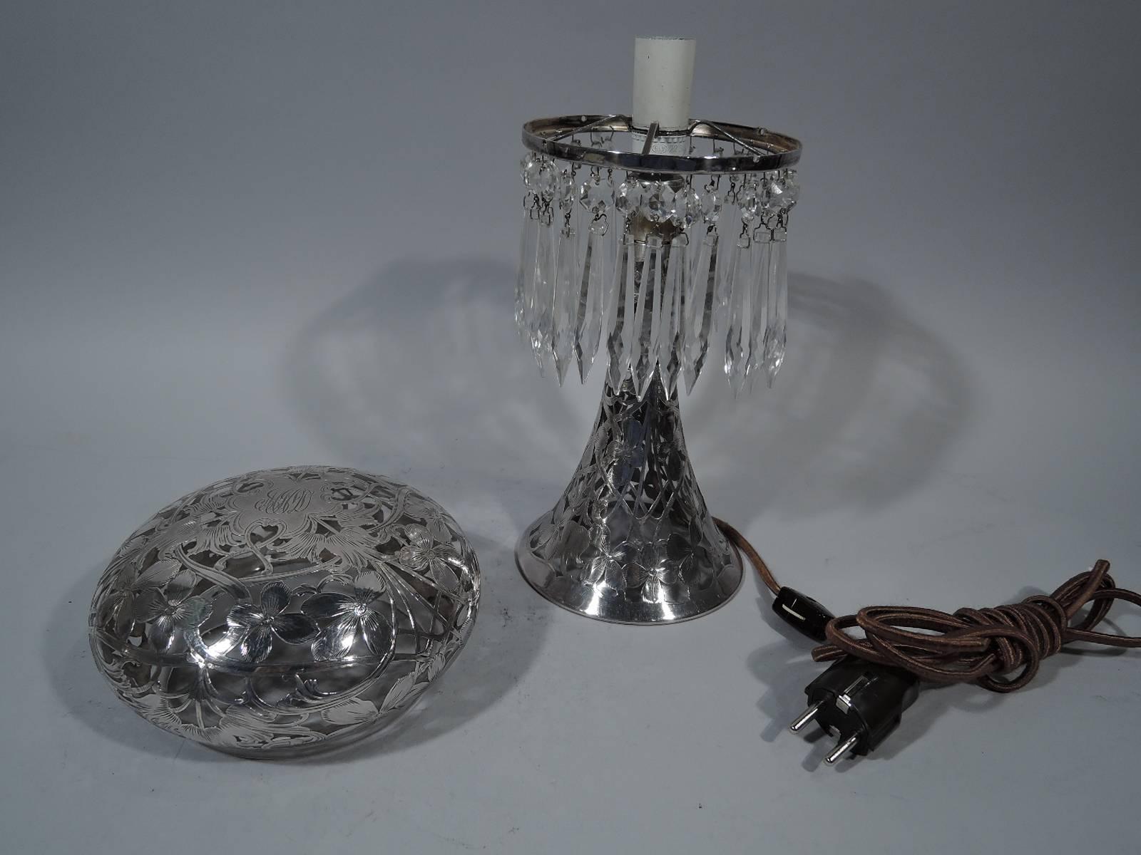 One of a Kind American glass table lamp with silver overlay, circa 1900. Conical base and bun shade in clear glass with floral silver overlay. Crystal lusters (the dangly bits) loose-mounted from shade frame. Interlaced script monogram engraved on