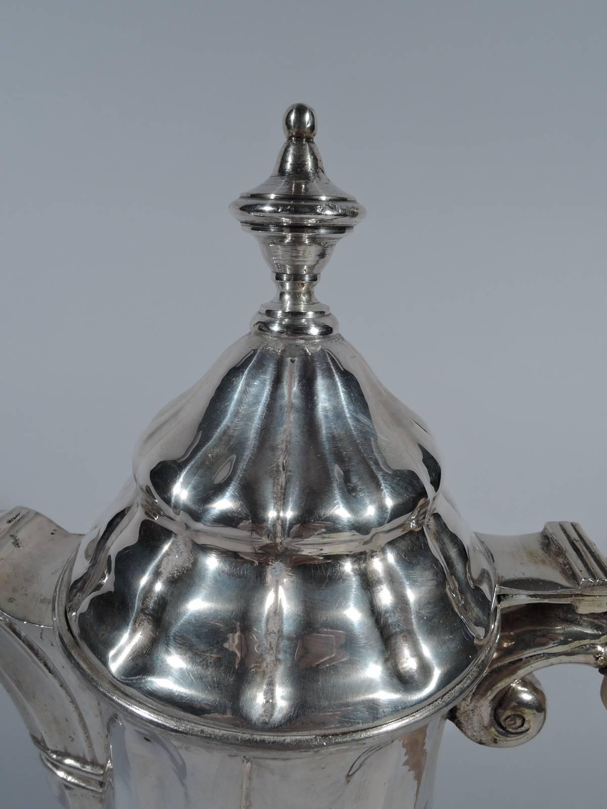 Antique Italian silver coffeepot in 18th century style. Baluster on raised foot, crescent spout, hinged double-dome cover with finial, and capped s-scroll wood handle with silver scroll mounts. Fluting. Visible hand hammering. Nice craftsmanship in