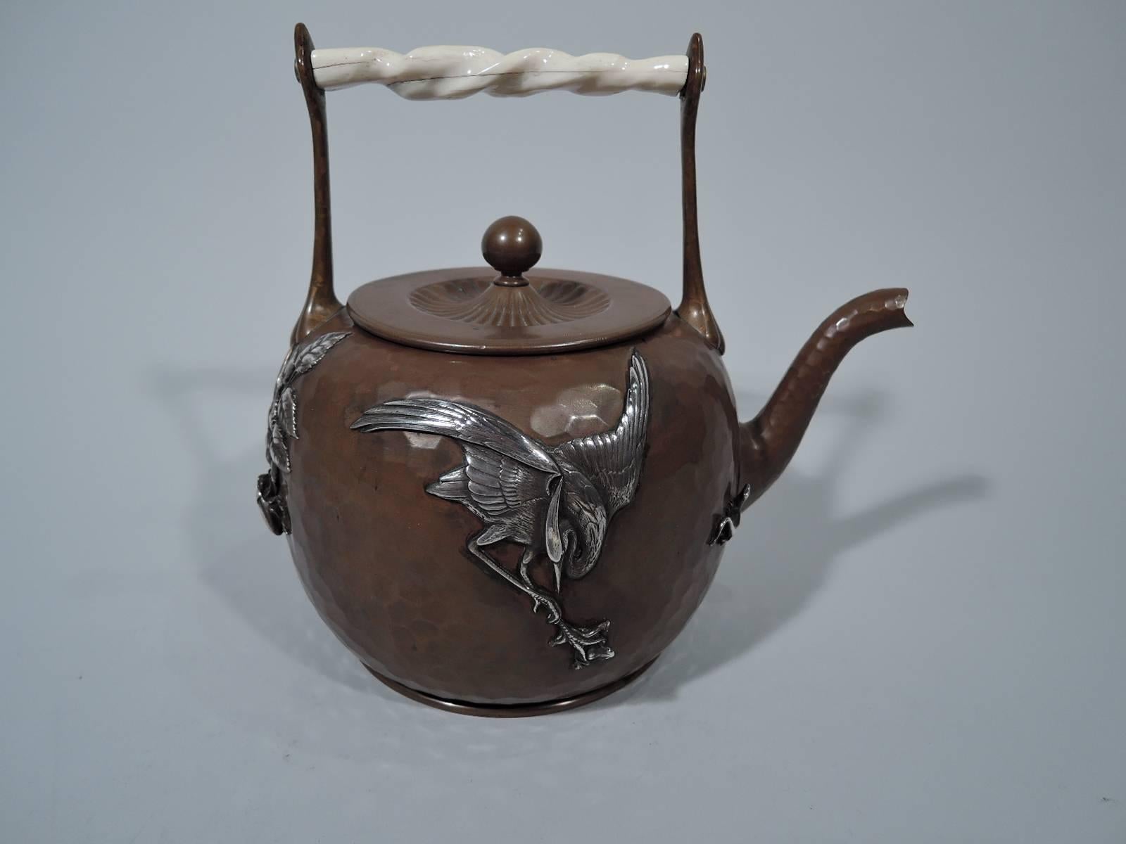 Japonesque mixed metal copper teapot. Made by Gorham in Providence in 1881.Round with s-spout and stationary handle. Honeycomb hand hammering with applied silver mounts including bird of prey, butterfly, and blossoming bush rooted in grassy ground.