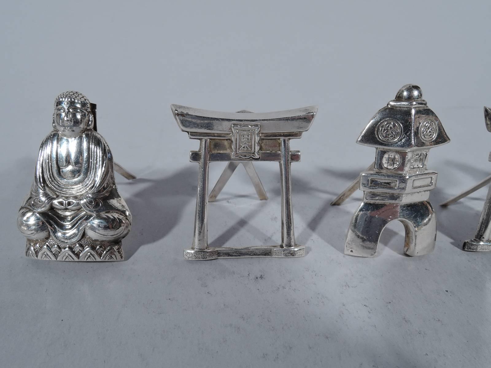 Set of Japanese silver place card holders. Six holders in four designs with motifs that include Buddha and pagoda. A fun foray into postwar exoticism. Each hallmarked “Sterling 950”. 

Dimensions (largest): H 1 5/8 x W 7/8 in. Total weight: 1.5